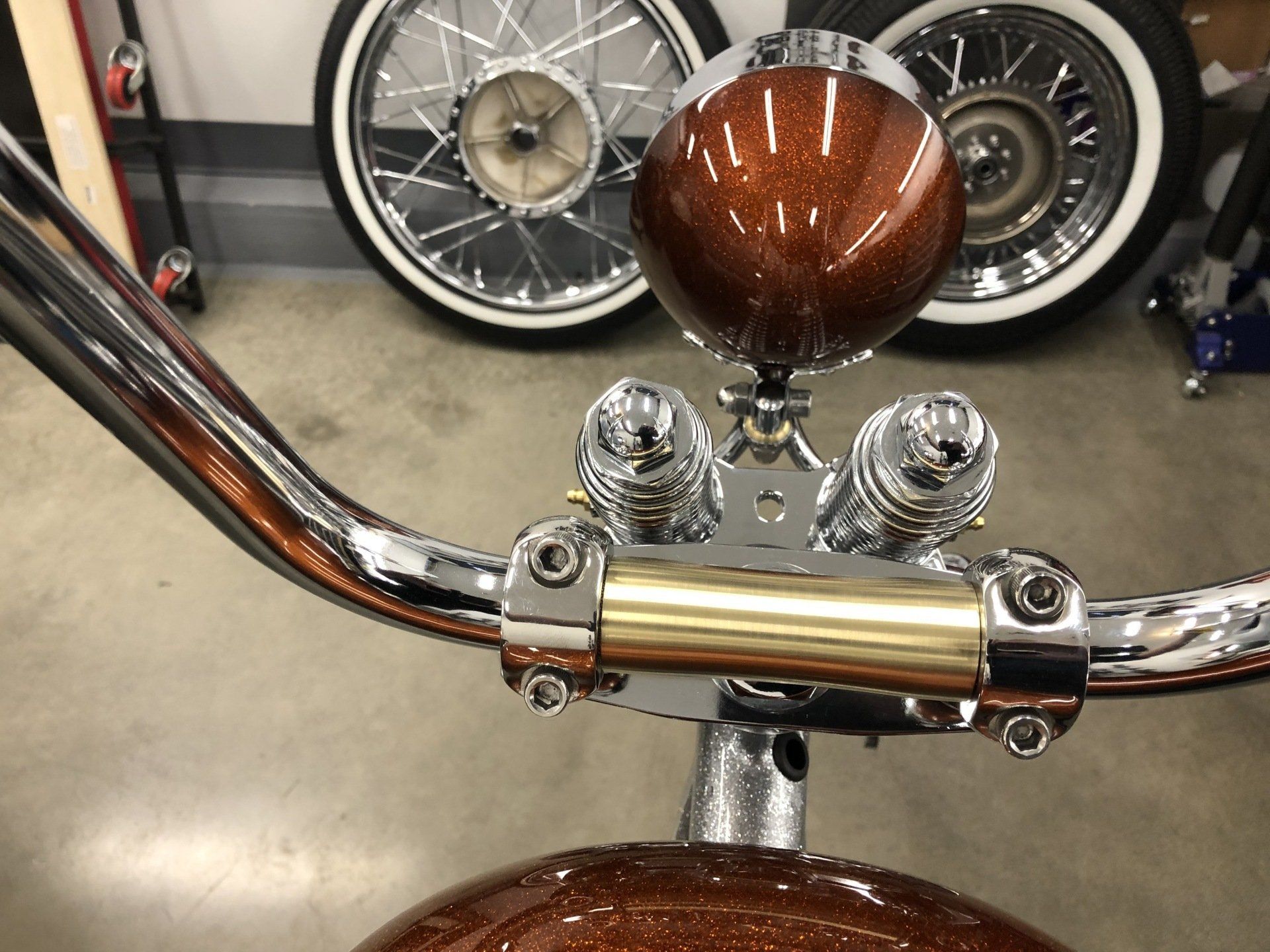 A close up of a motorcycle handlebars in a garage