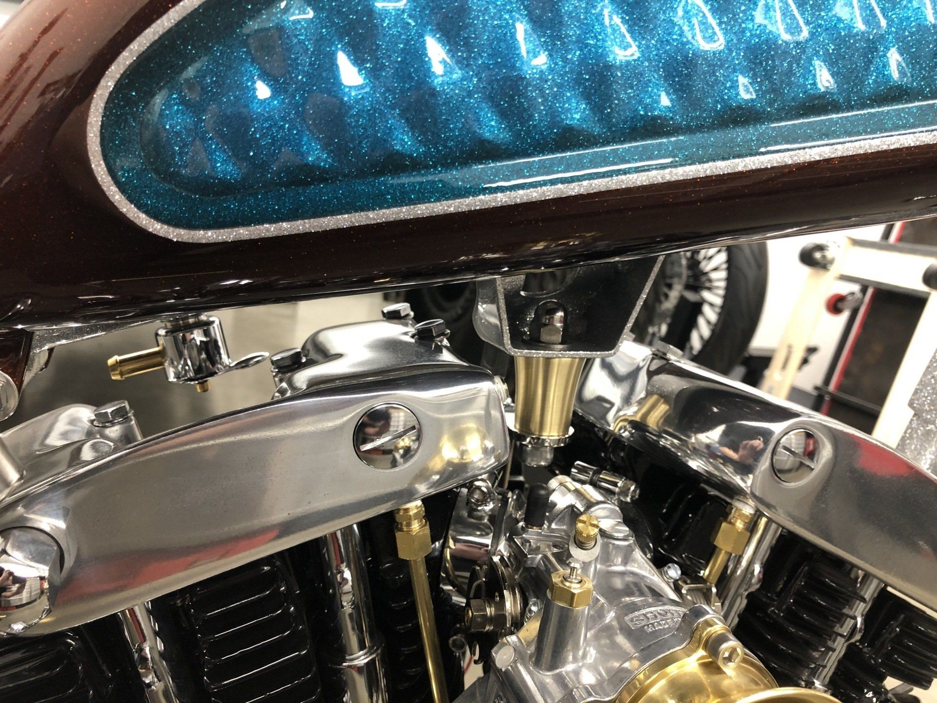 A close up of a motorcycle engine with a blue tank