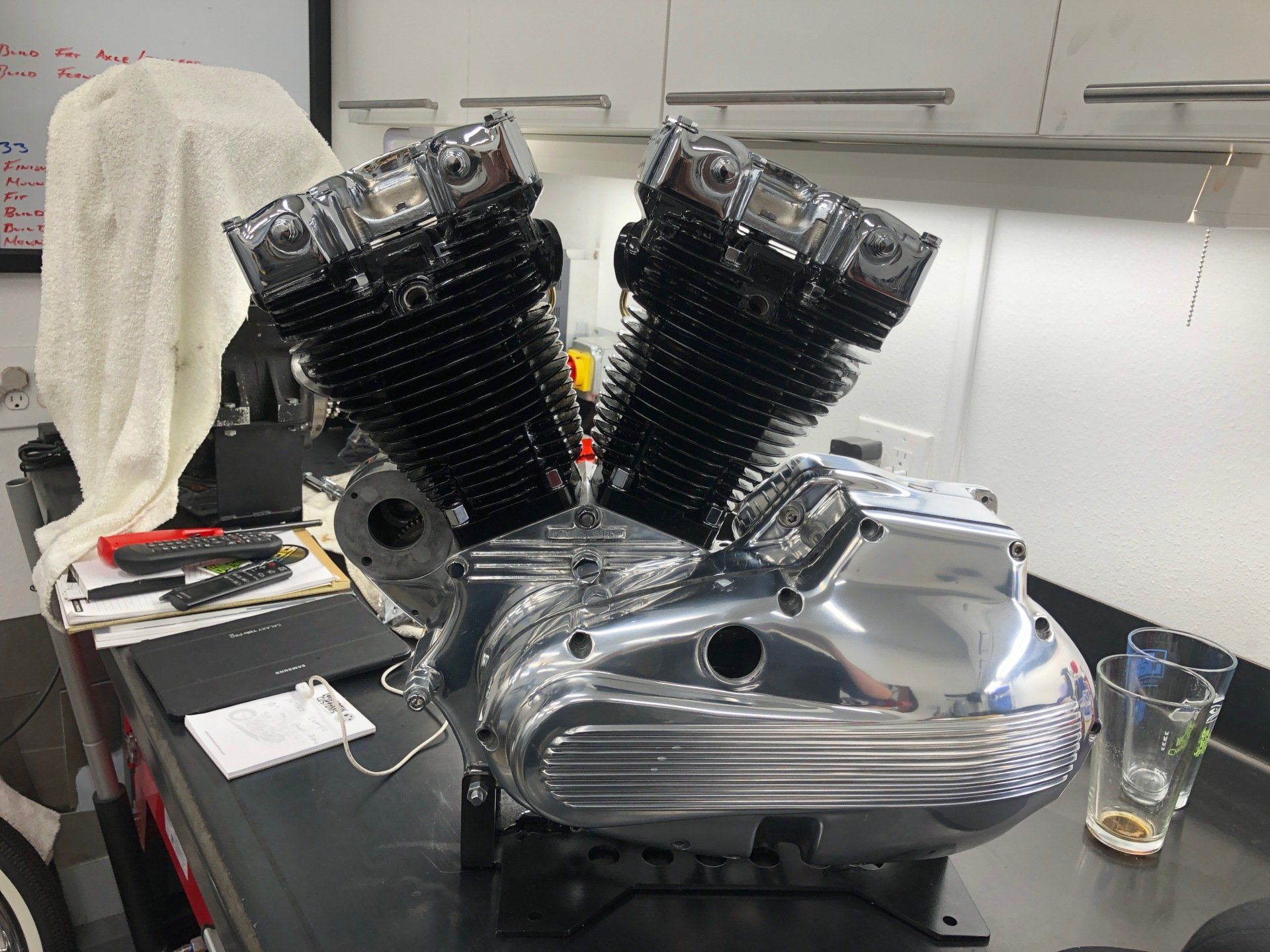 A motorcycle engine is sitting on a table in a kitchen