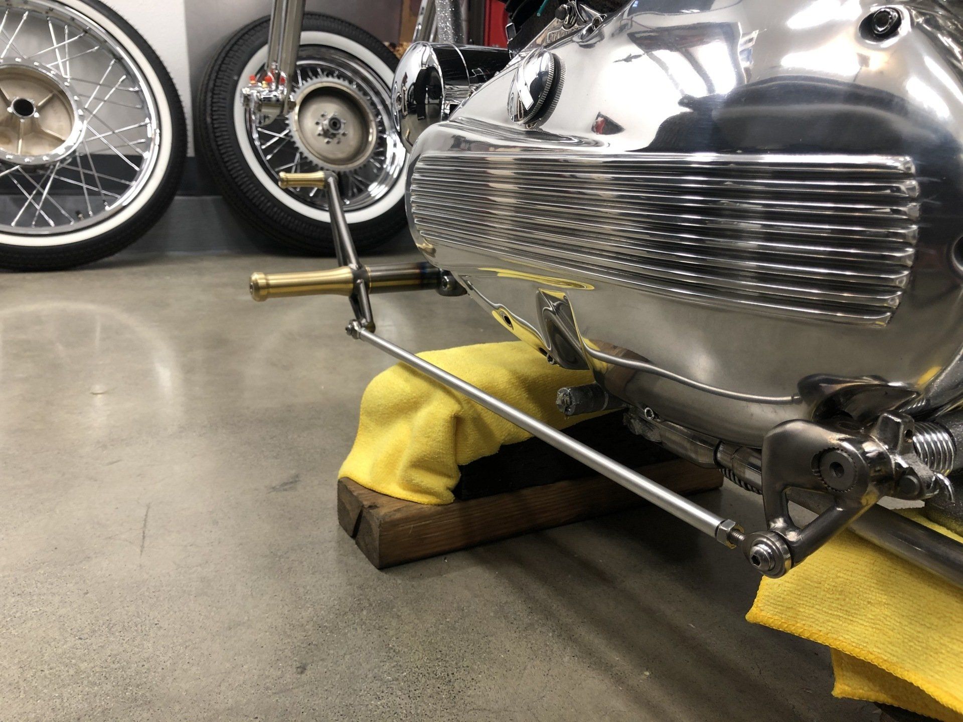 A motorcycle is sitting on a wooden block in a garage.
