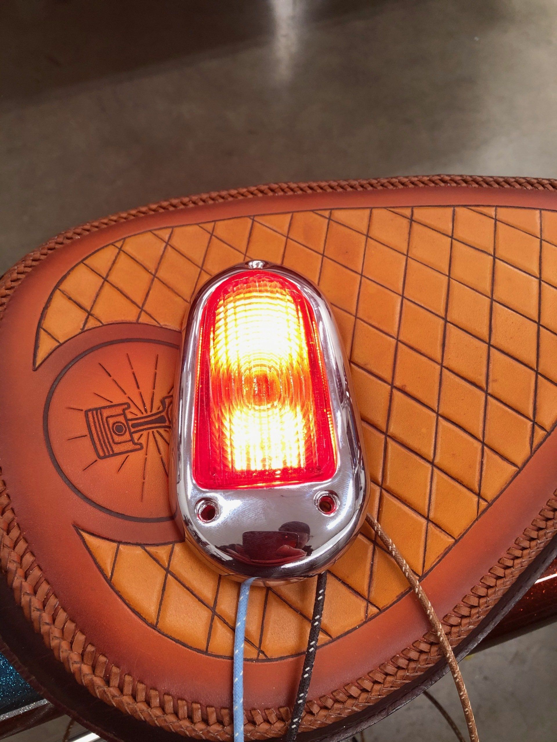 A motorcycle seat with a red light on it