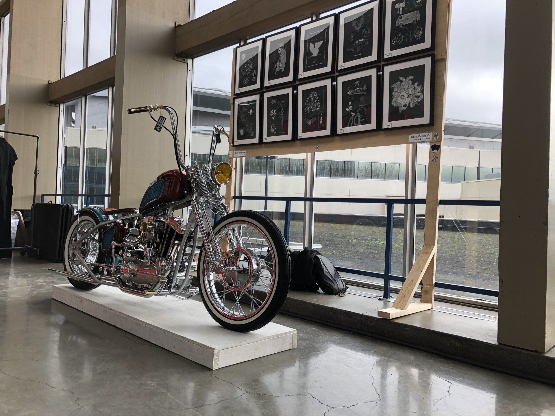 A motorcycle is on display in a room next to a window.