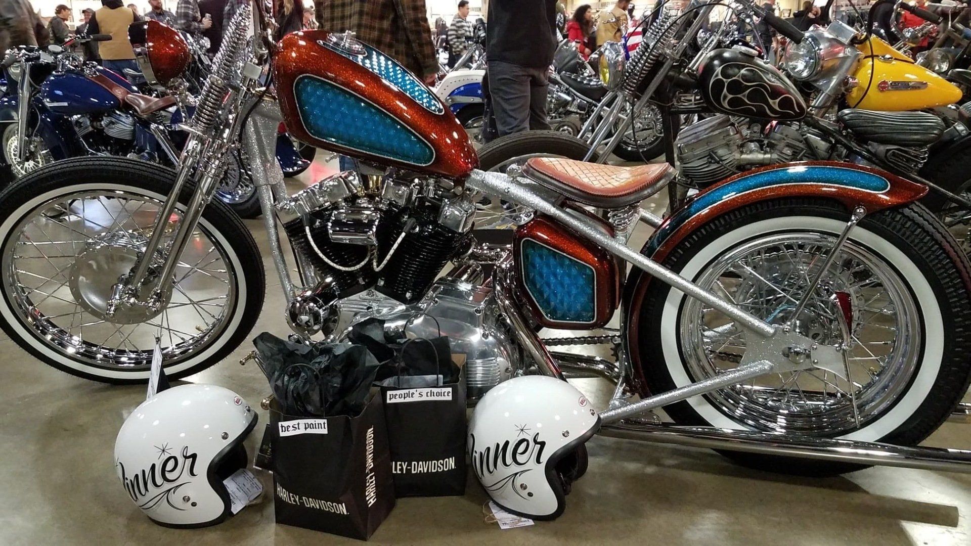 A motorcycle with two helmets and a bag that says biker on it