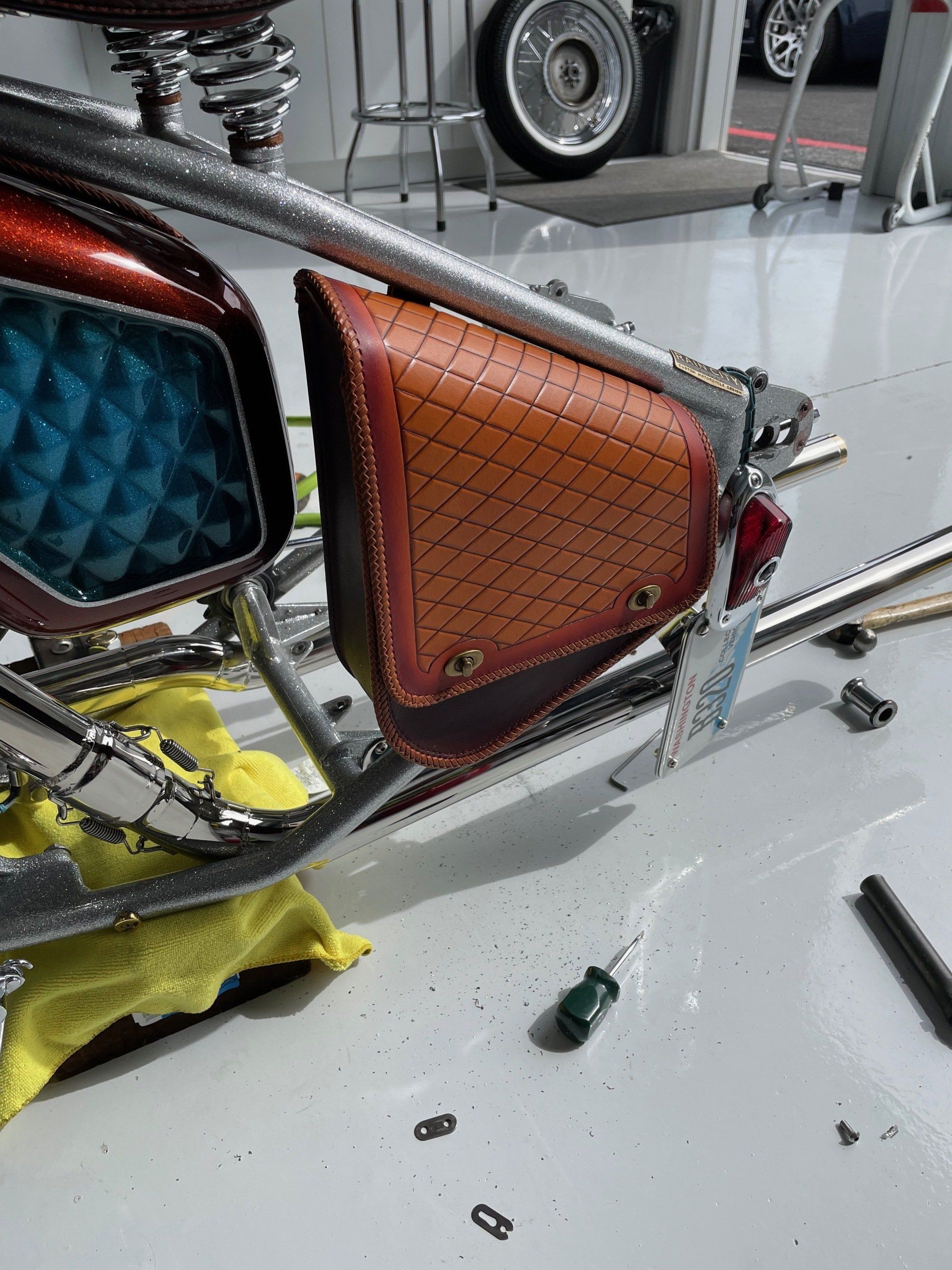 A motorcycle is sitting on a table in a garage.