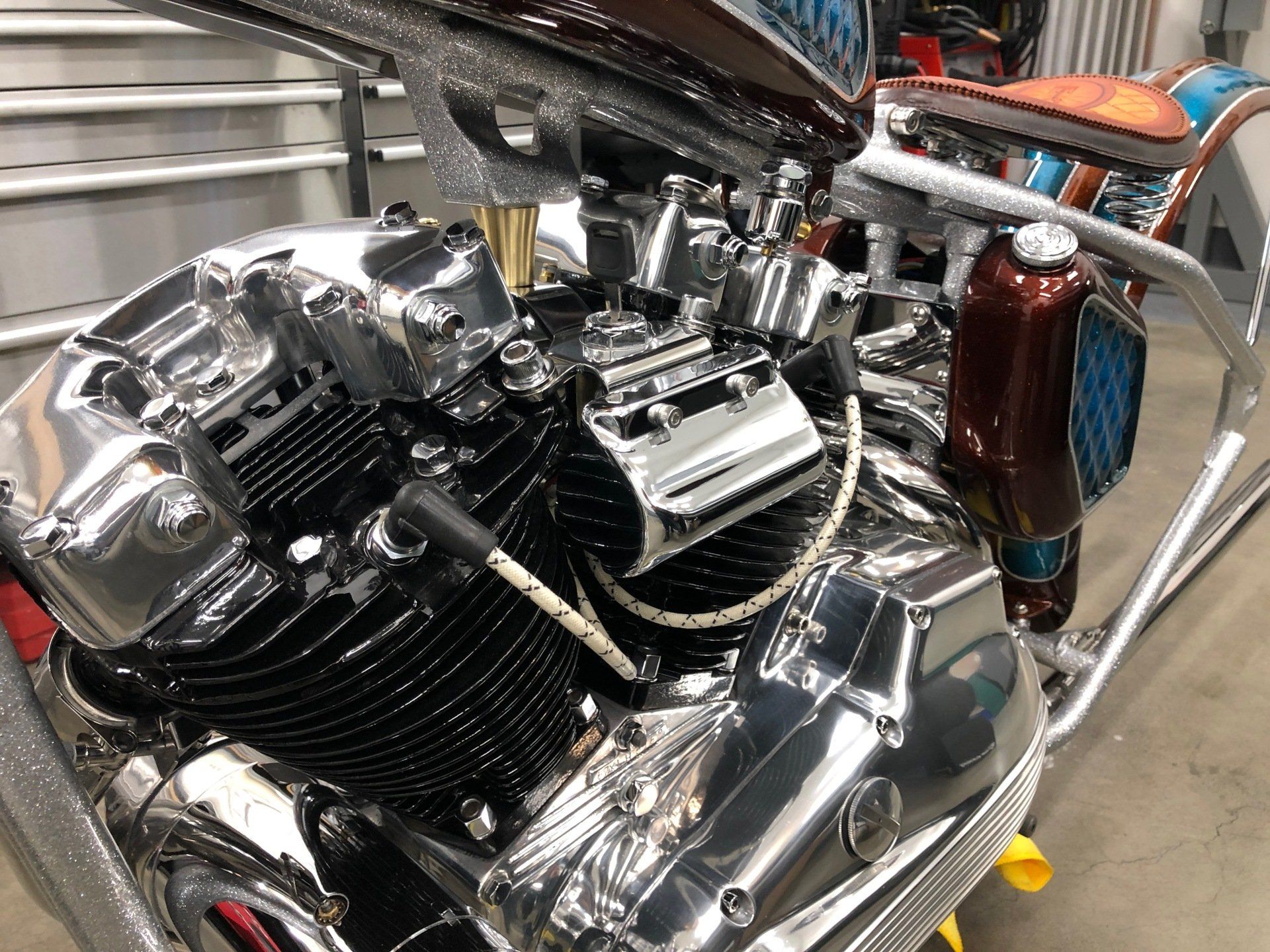A close up of a motorcycle engine in a garage.