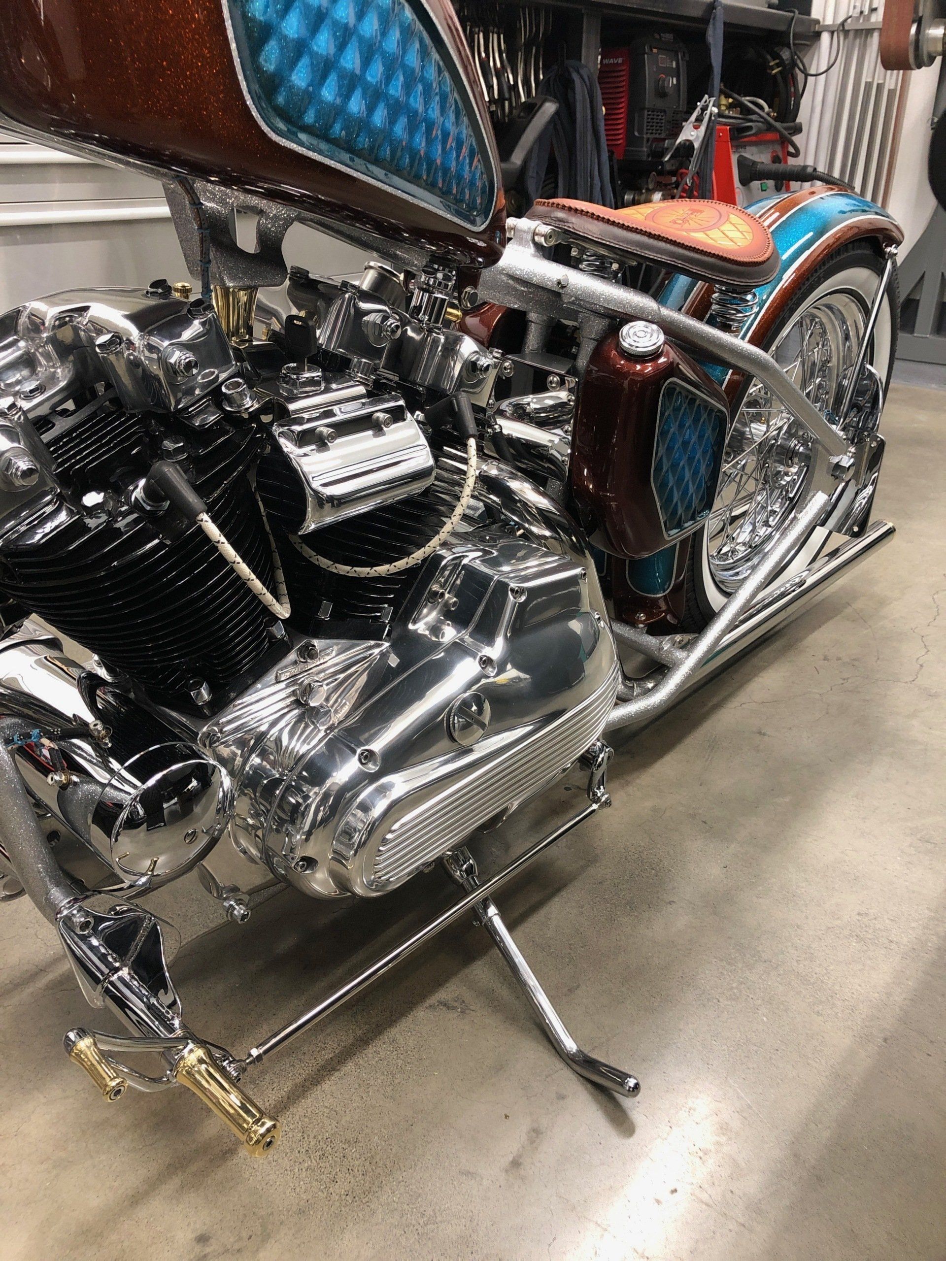 A motorcycle is parked on a concrete floor in a garage.
