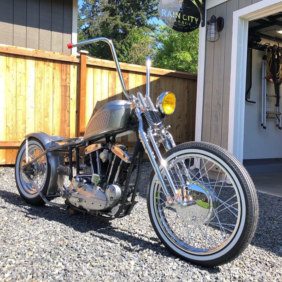 A motorcycle is parked in front of a garage.