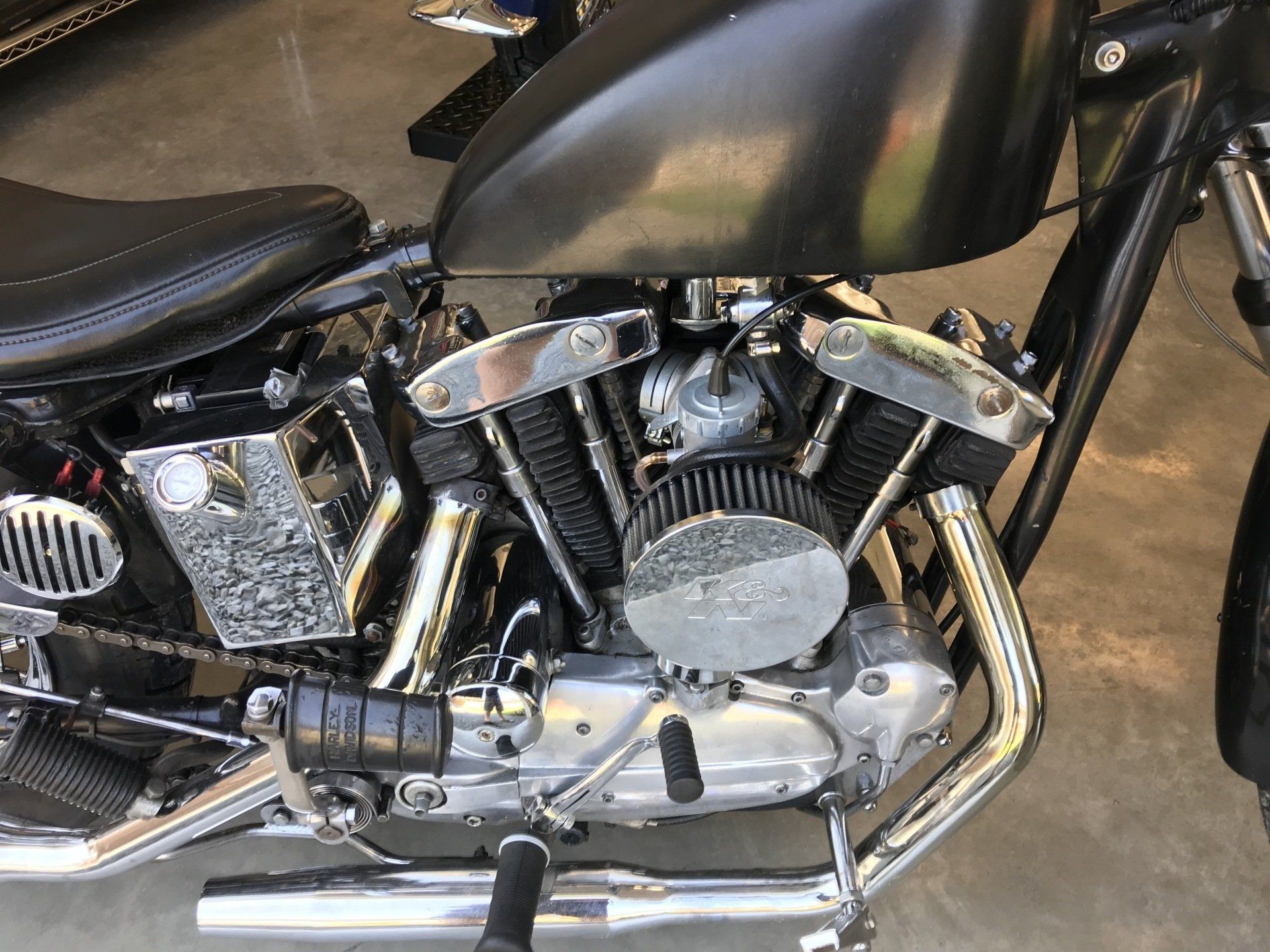 A close up of a motorcycle engine in a garage.