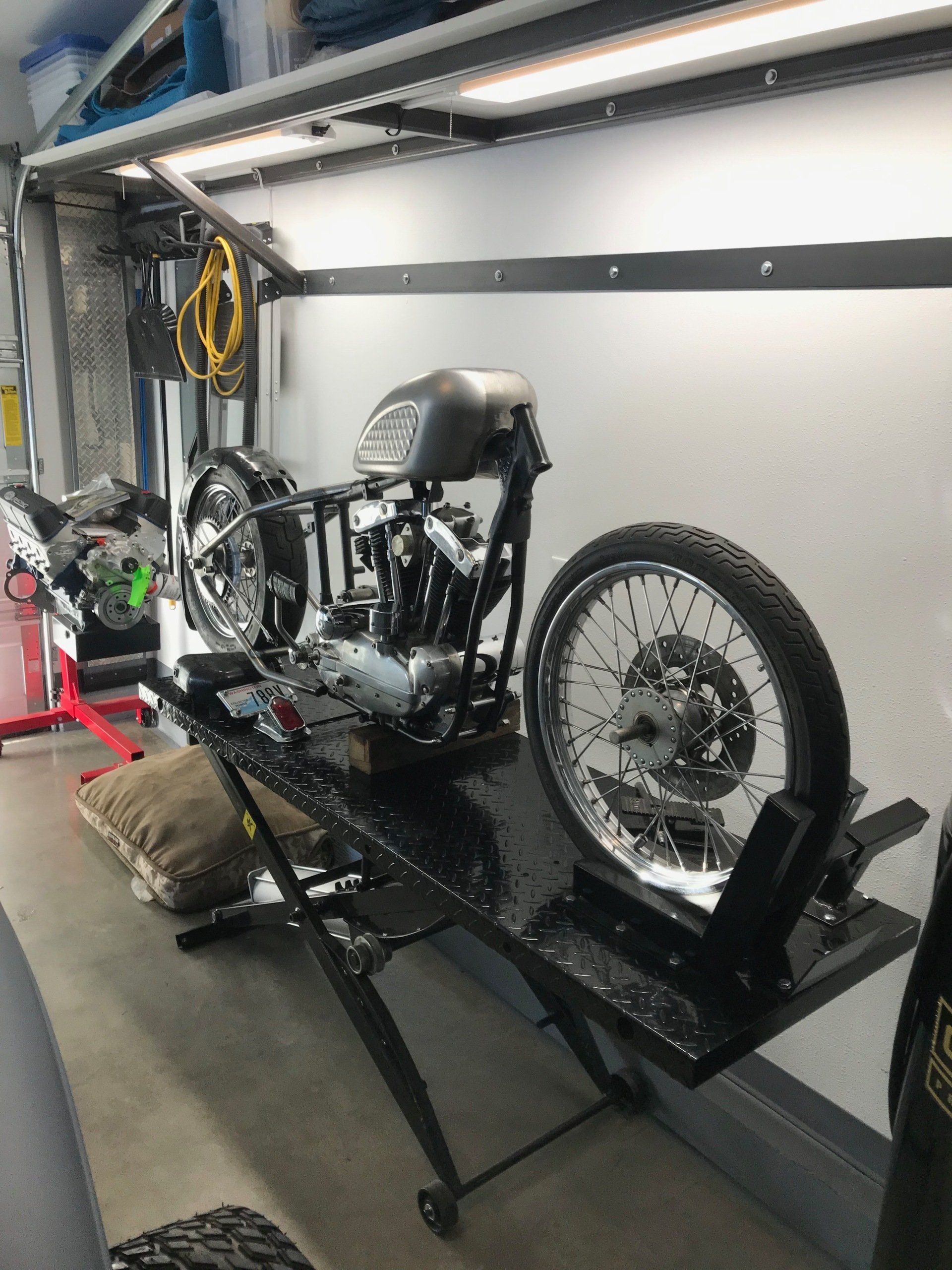 A motorcycle is sitting on a lift in a garage