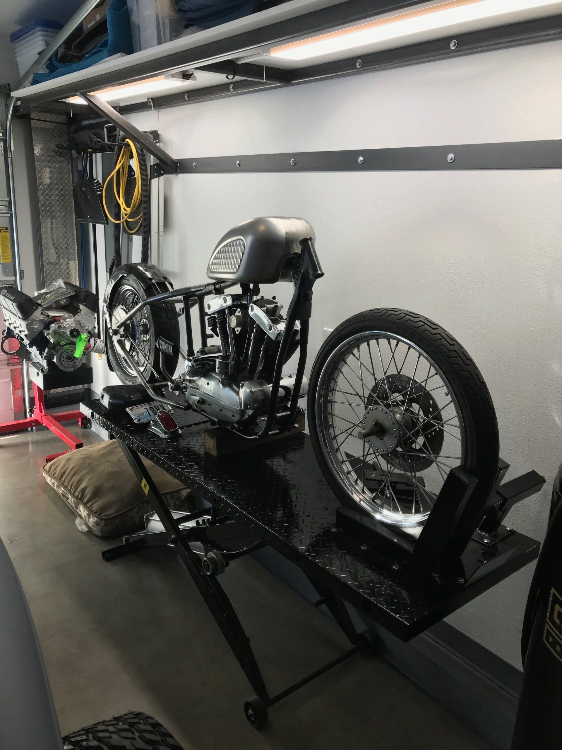 A motorcycle is sitting on a lift in a garage