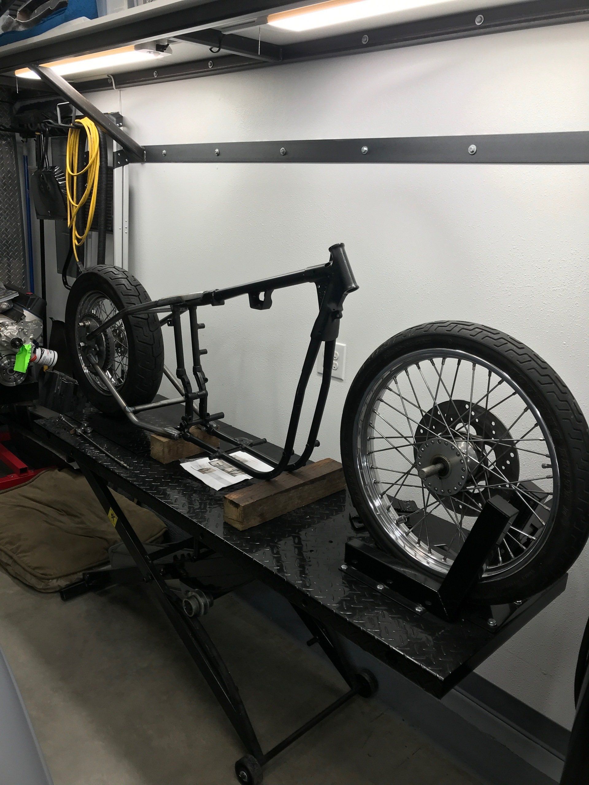 A motorcycle is sitting on a lift in a garage