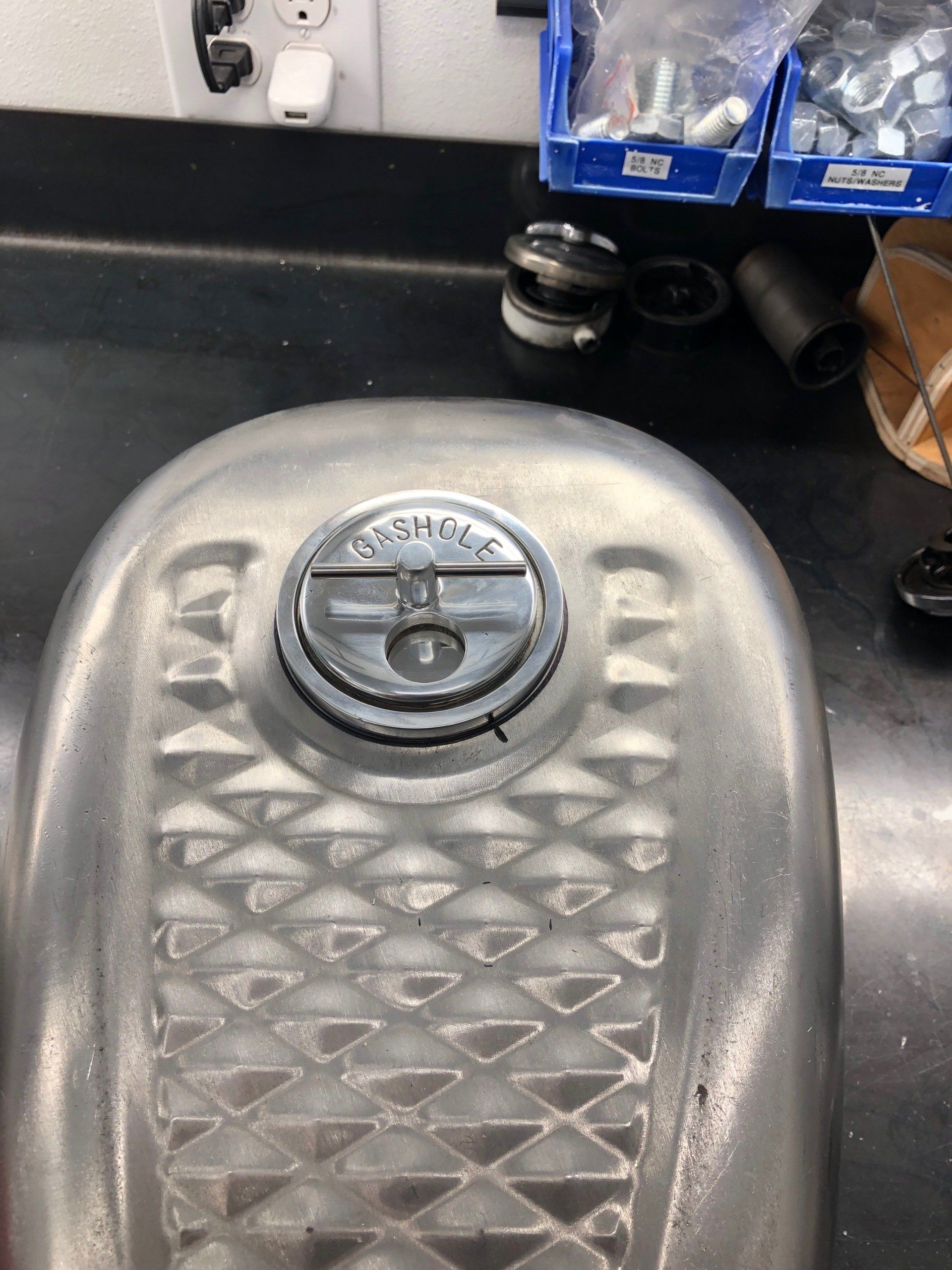 A close up of a motorcycle fuel tank on a counter.