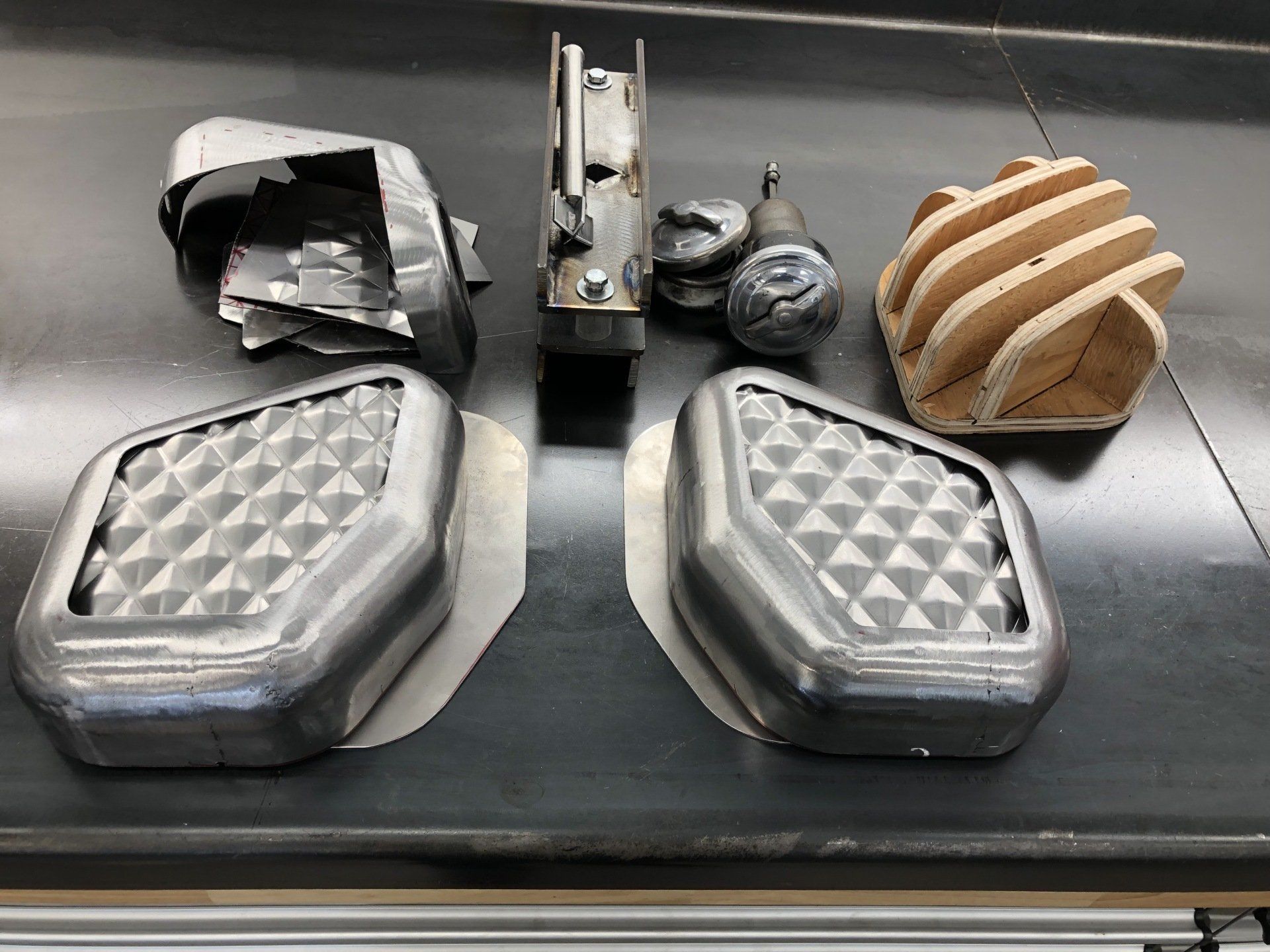 A bunch of metal parts are sitting on a table