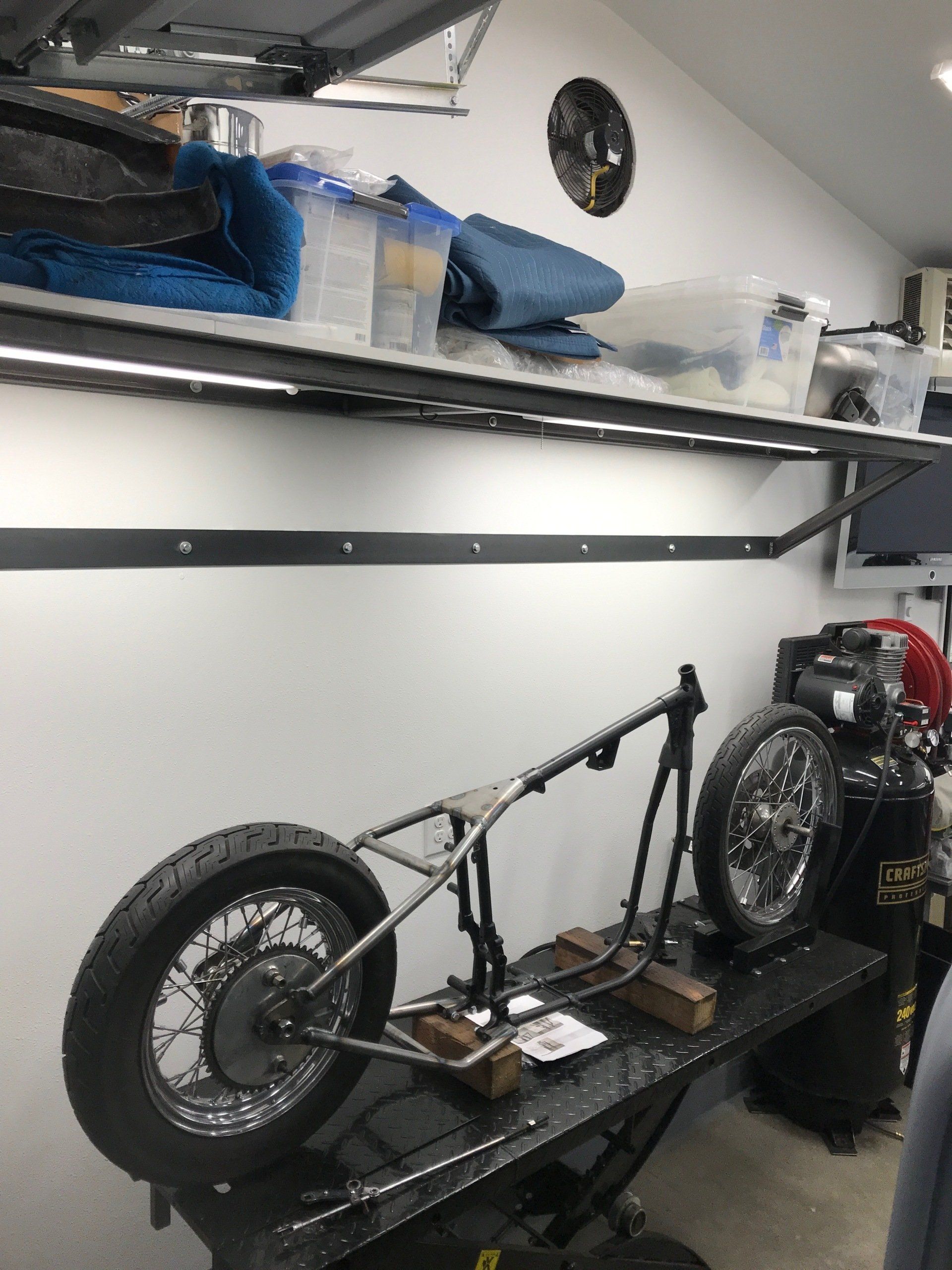 A motorcycle is sitting on a lift in a garage