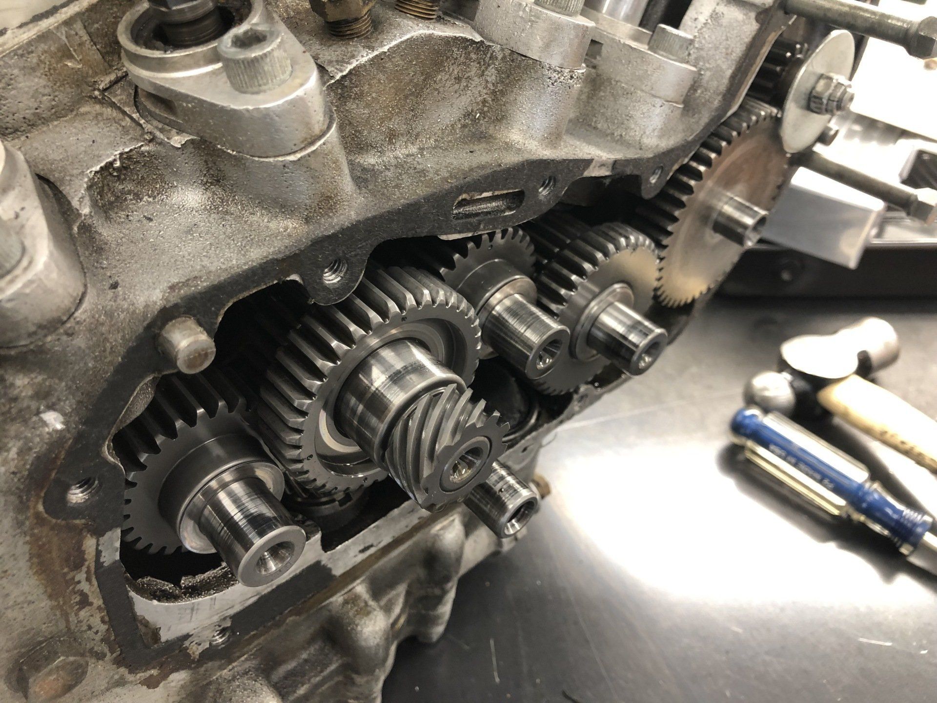 A close up of a machine with gears and hammers on a table.