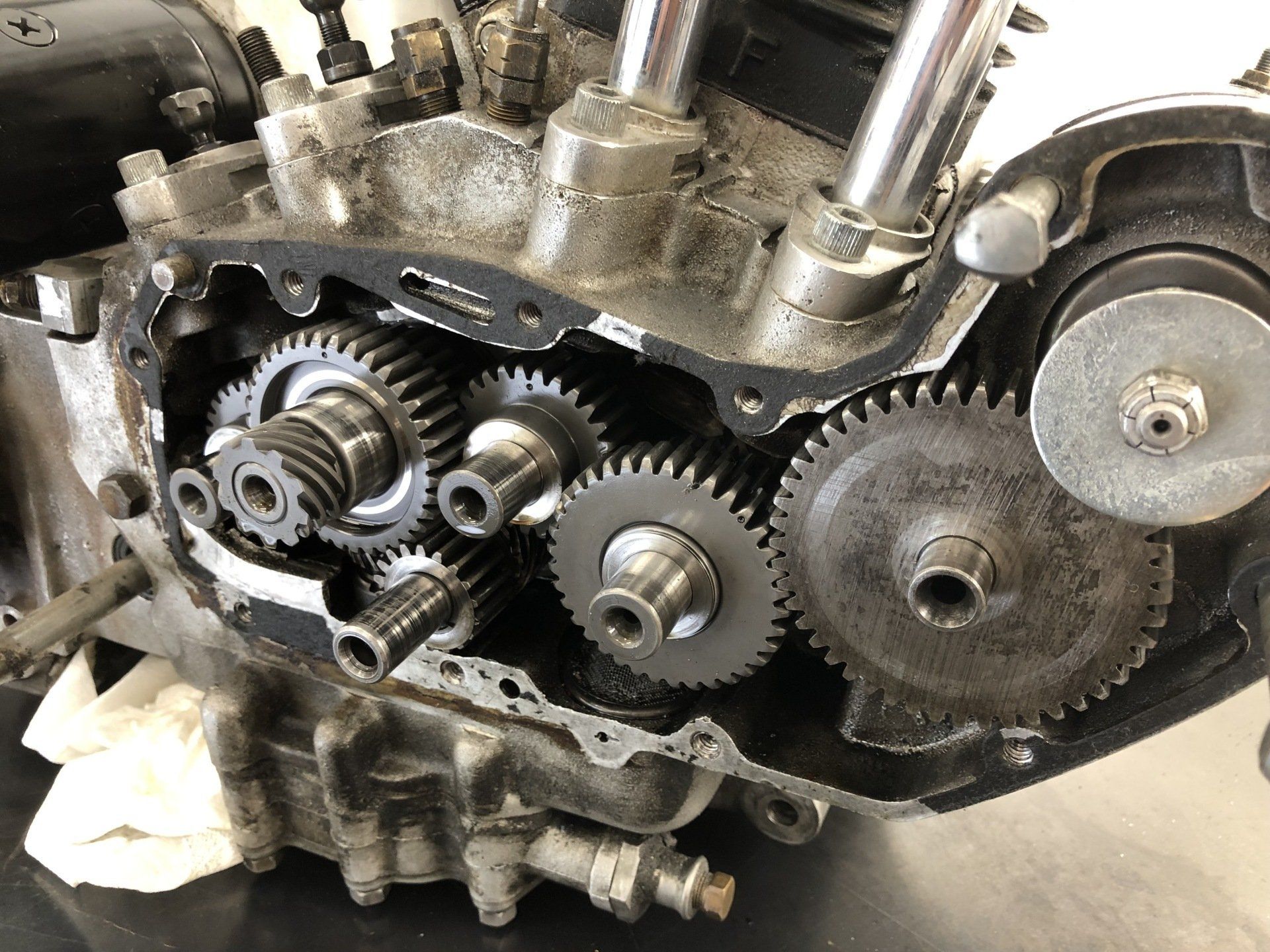 A close up of a motorcycle engine with gears on it.