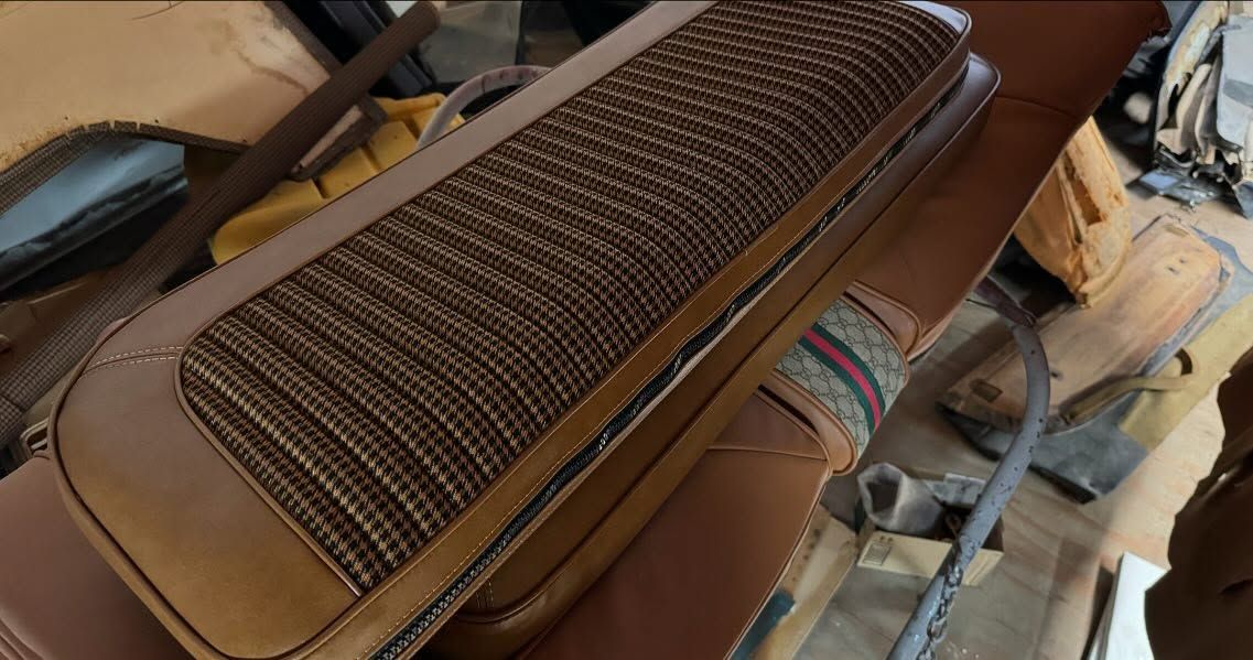 A brown bag is sitting on top of a wooden table.