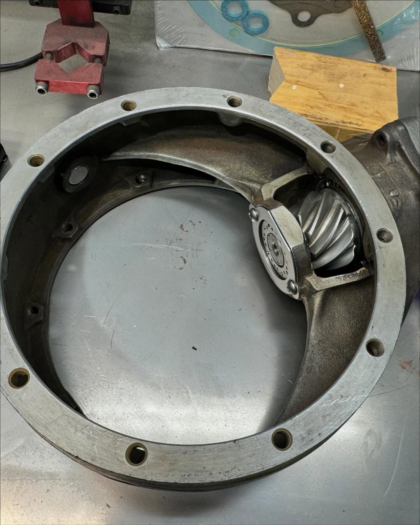 A metal ring with a gear inside of it is sitting on a table.