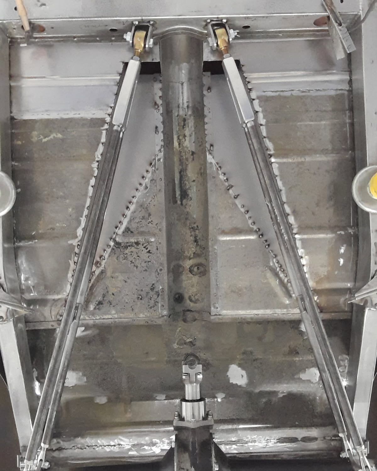 A close up of a metal structure with a yellow object in the middle