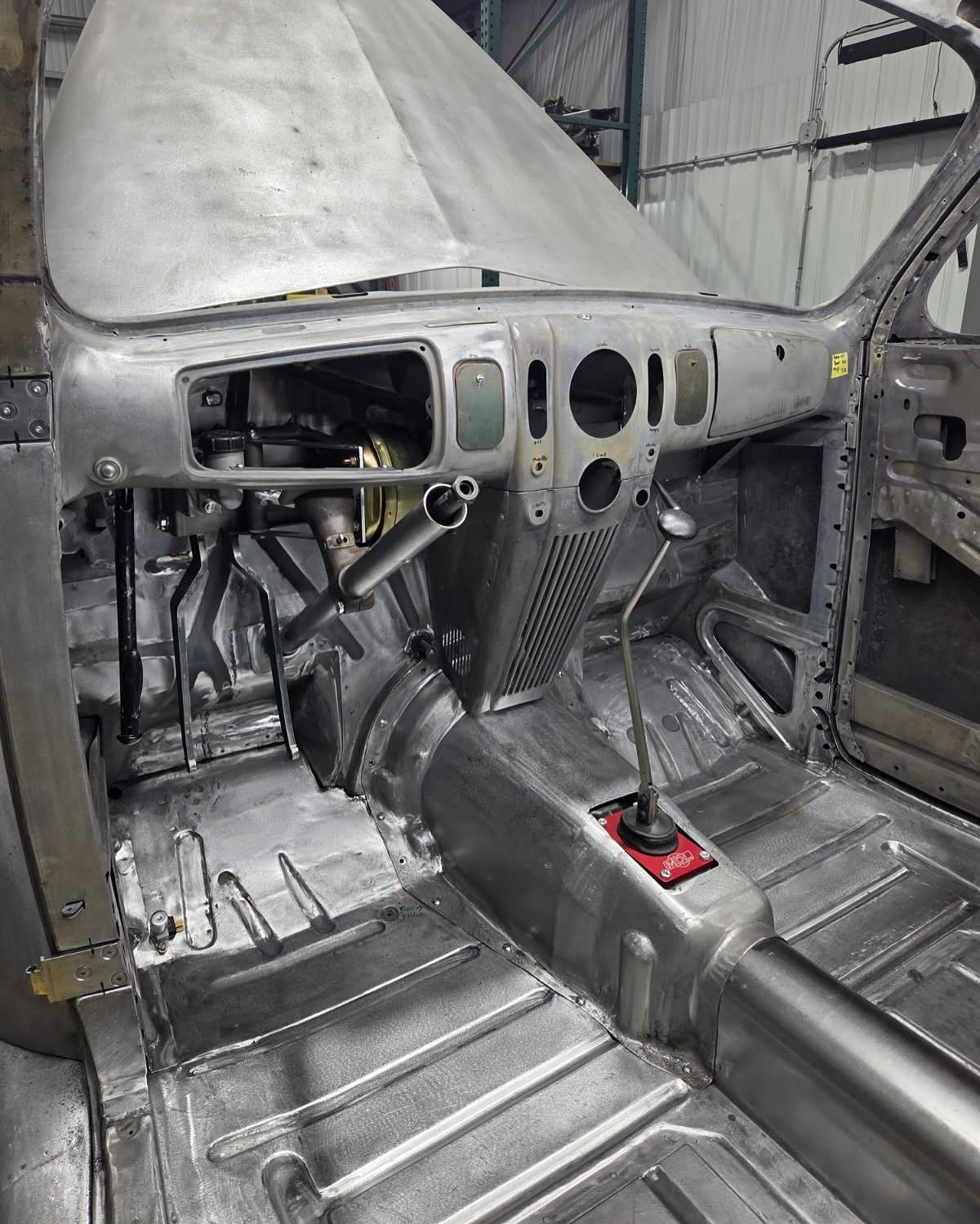 The inside of a car that is being built.