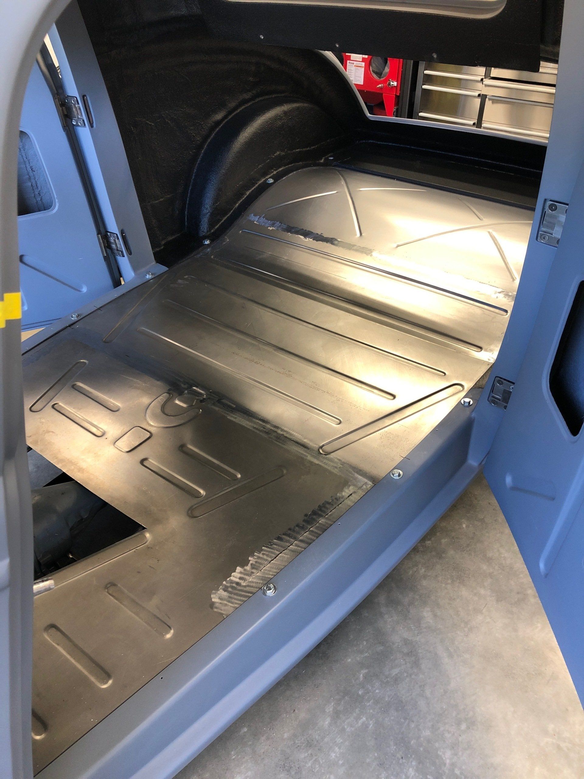 A close up of a metal floor in a car