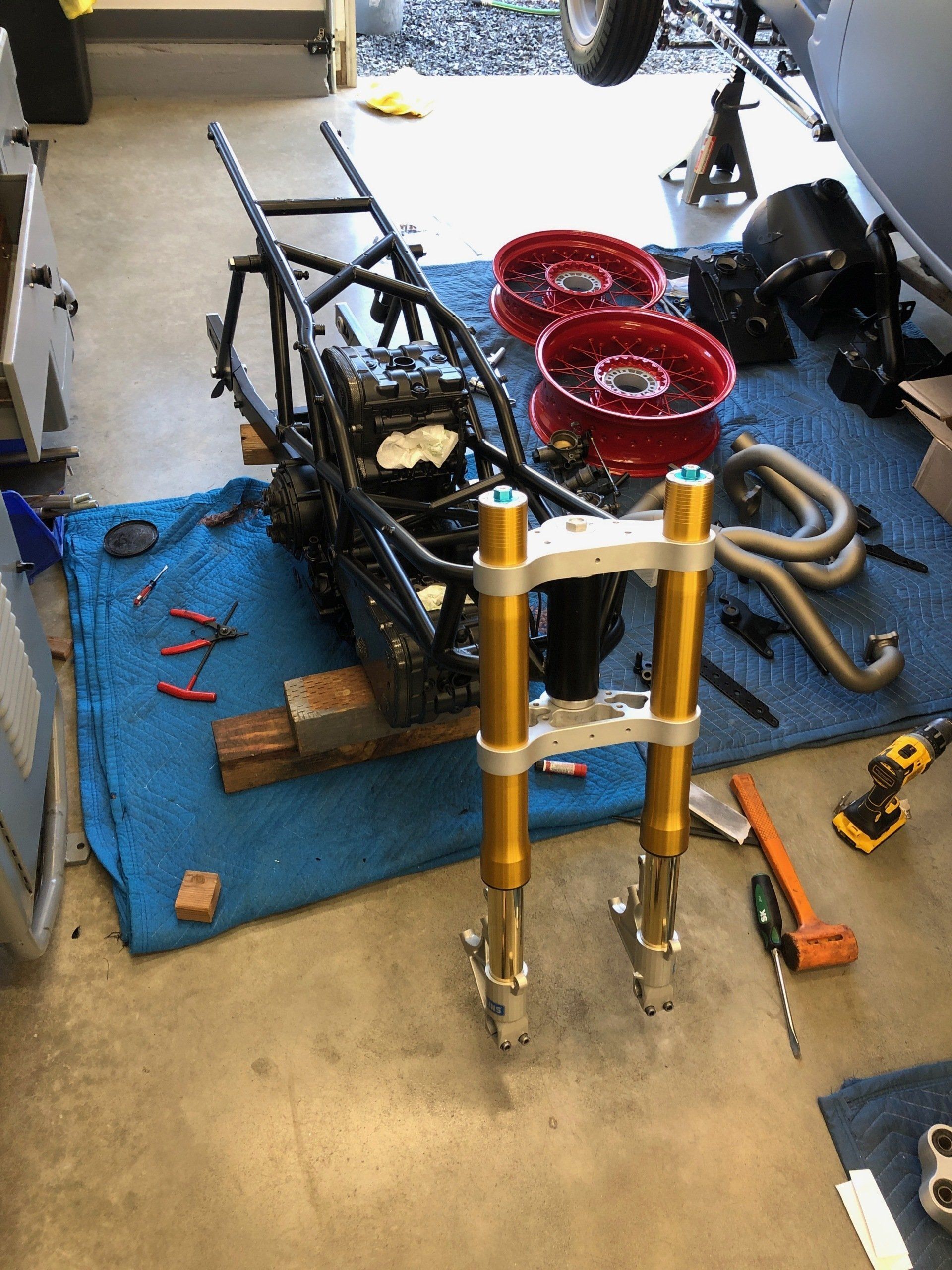 A motorcycle is being worked on in a garage.