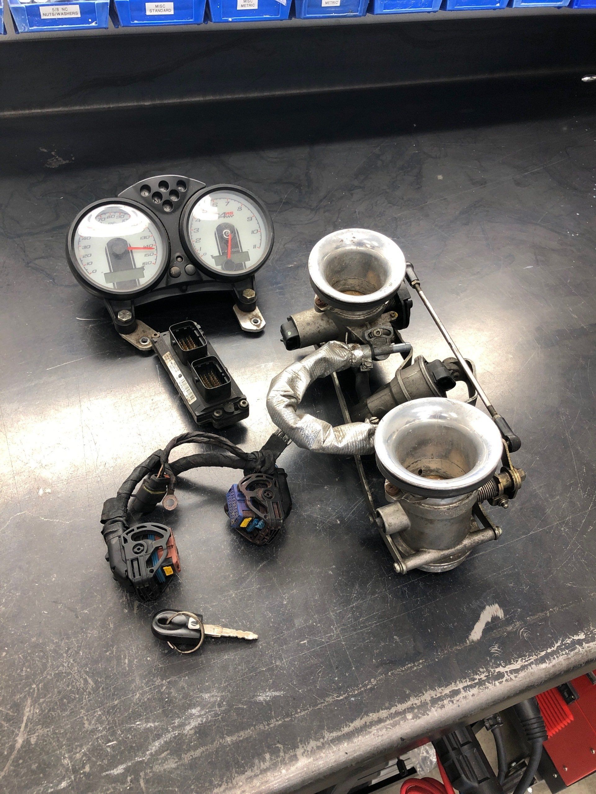 A bunch of motorcycle parts are sitting on a table.