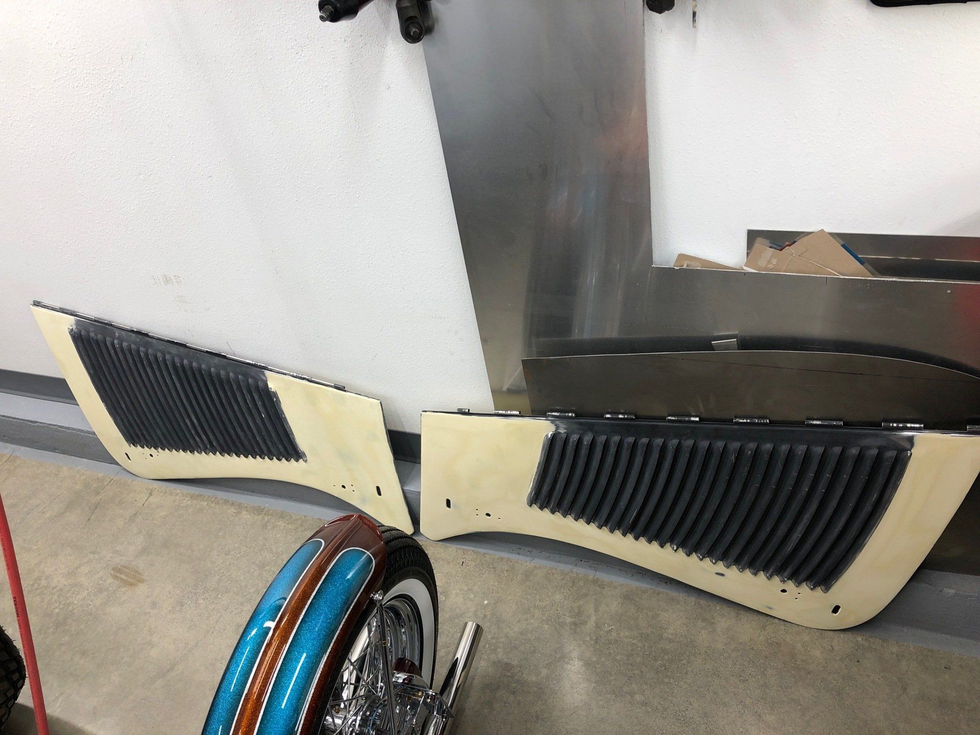 A motorcycle is sitting in a garage next to a wall