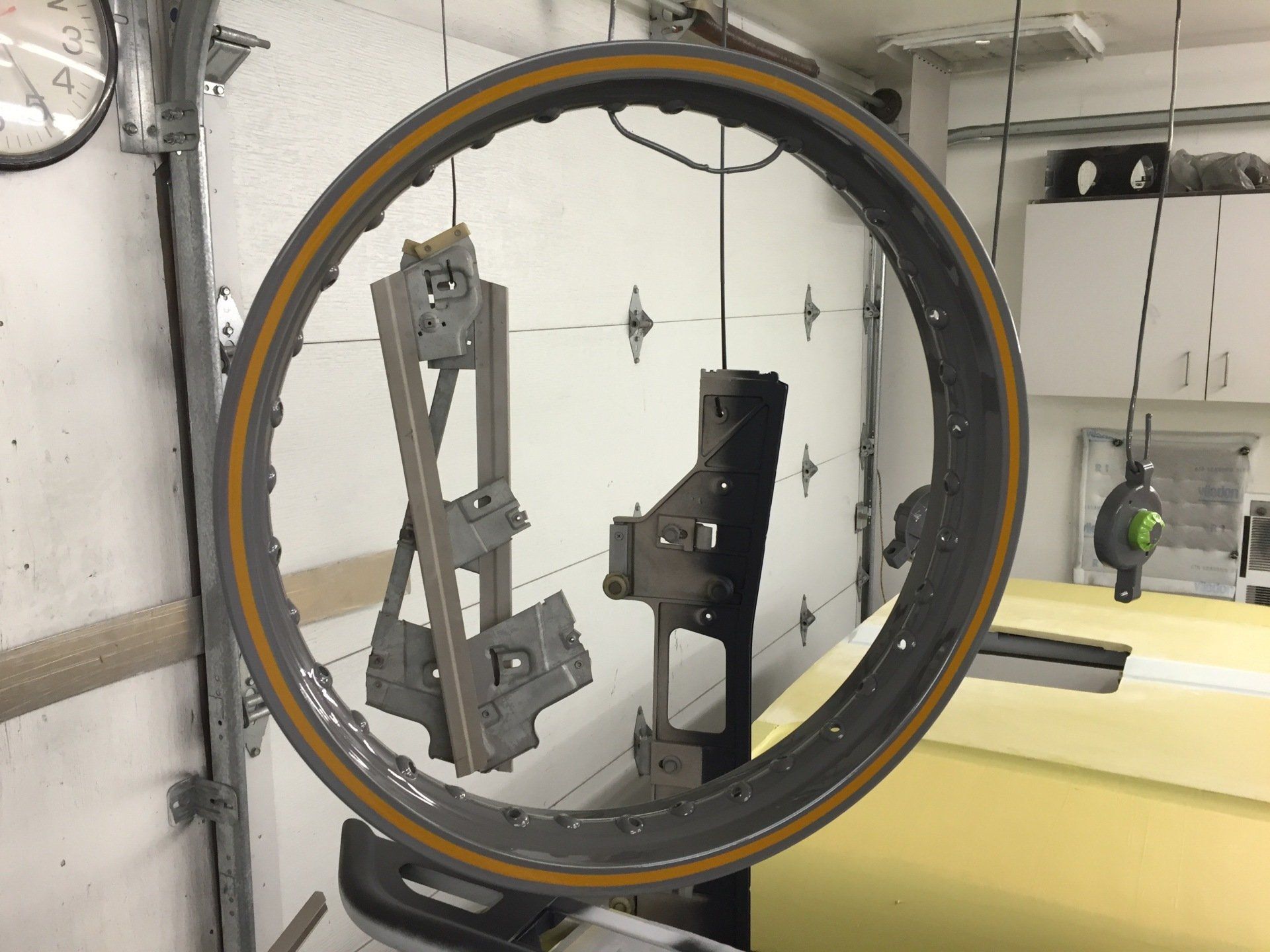 A bicycle wheel is hanging from a garage door