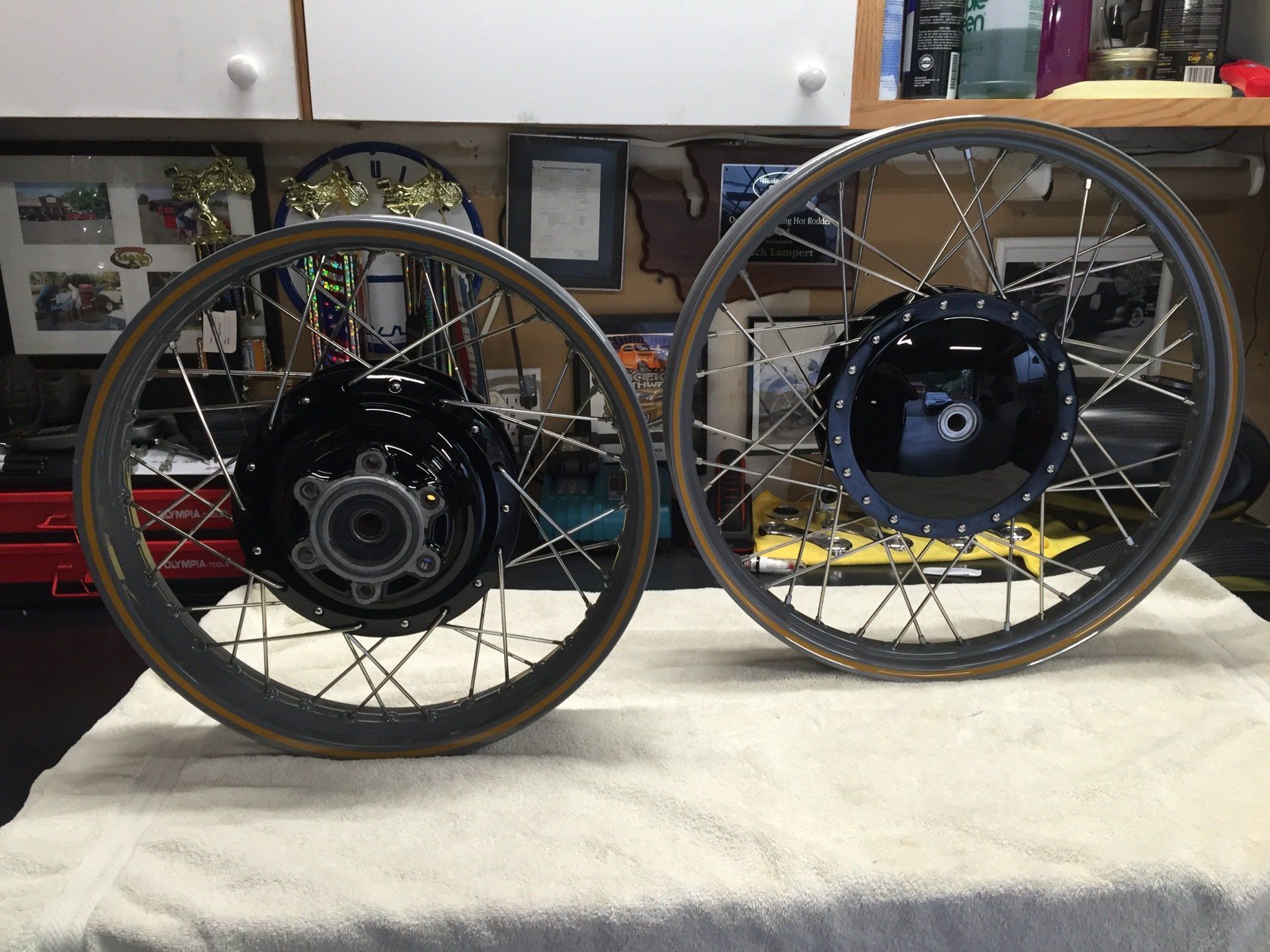 Two motorcycle wheels are sitting on a white towel