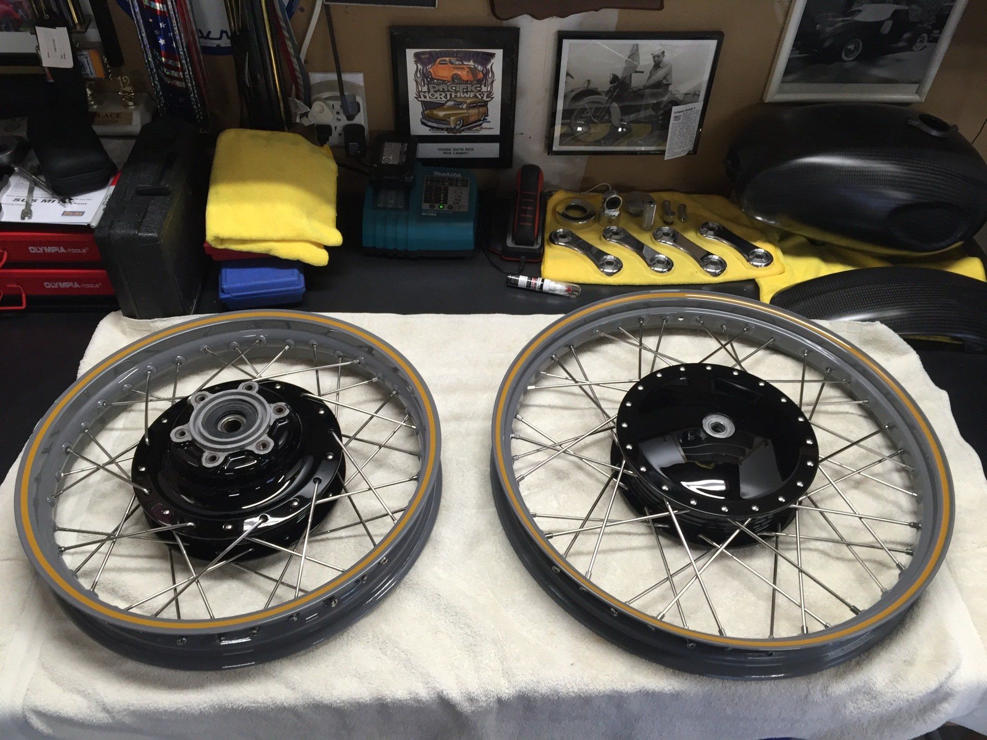 Two motorcycle wheels are sitting on a towel on a table