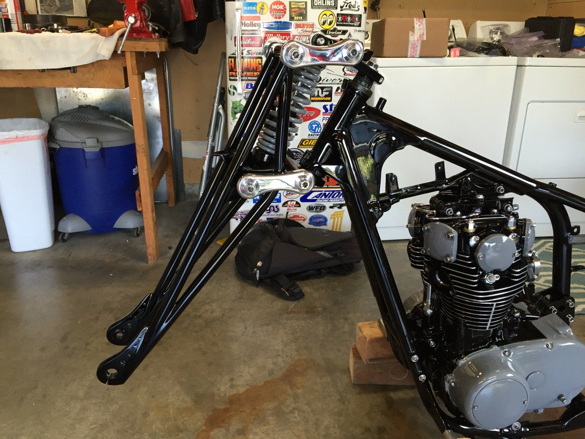 A motorcycle is being built in a garage