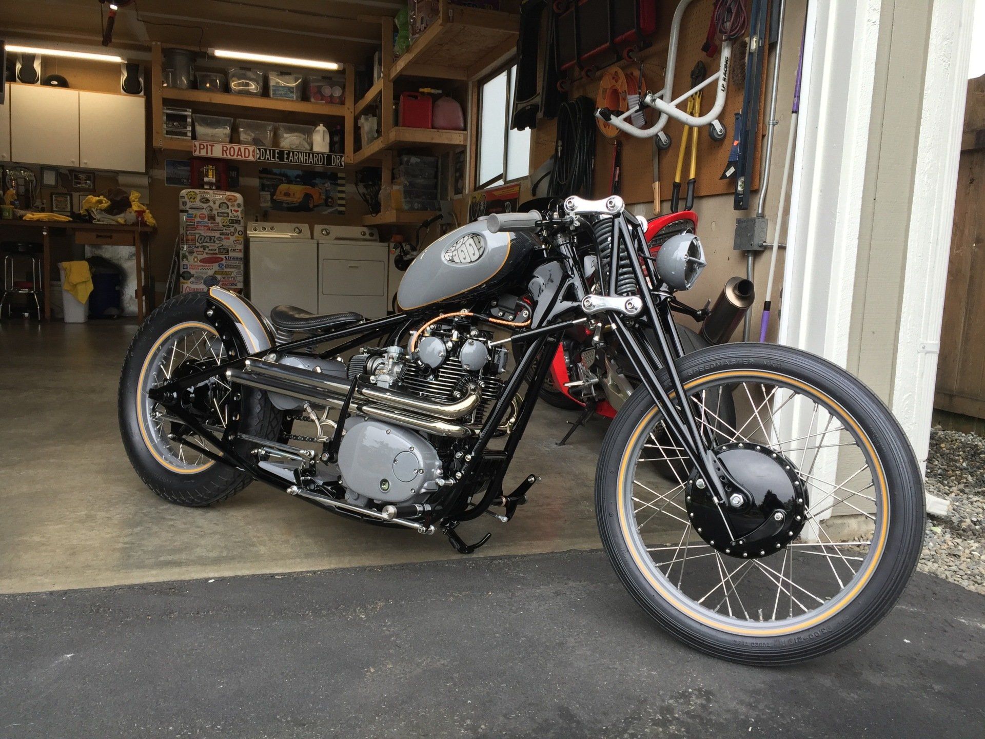 A black motorcycle is parked in a garage.