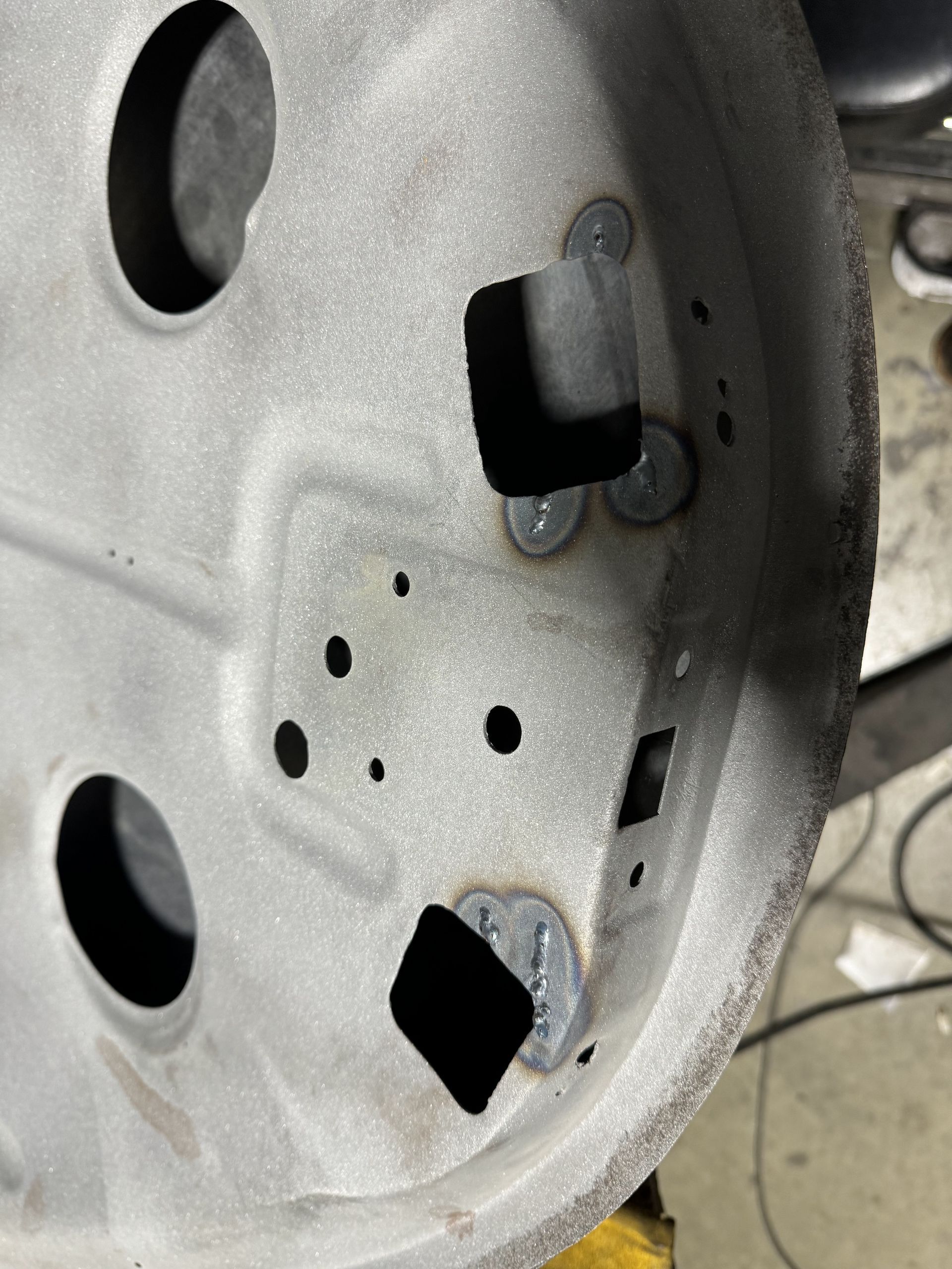 A close up of a wheel with holes in it