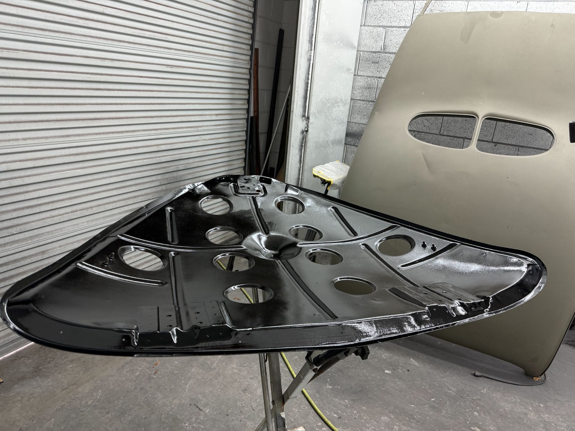 A large piece of metal is sitting on a table in a garage.