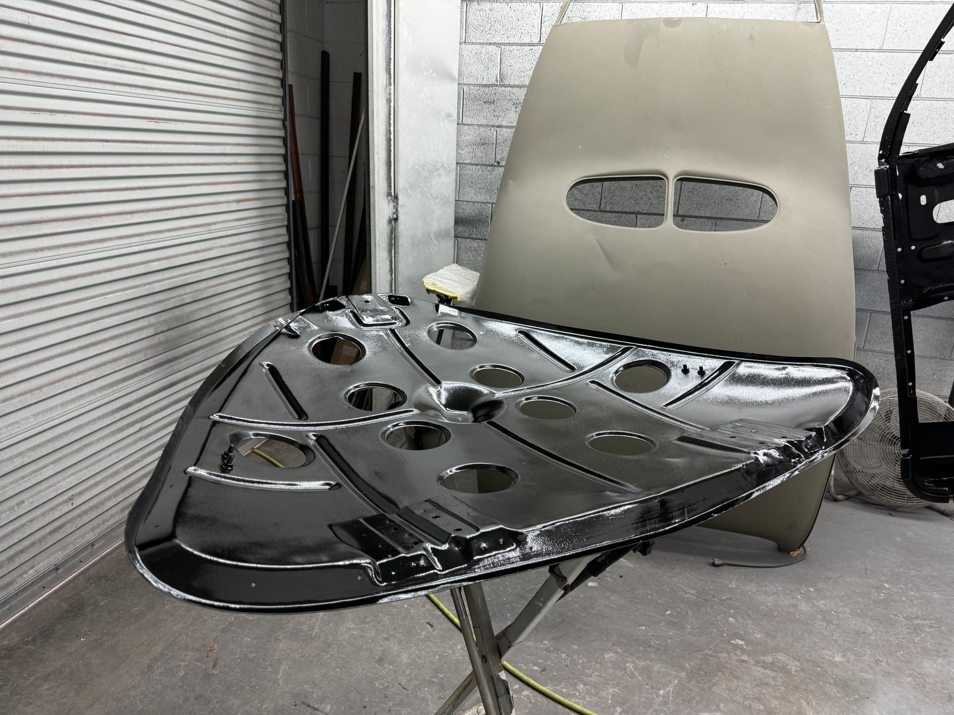 A chair with holes in it is sitting on a table in a garage.
