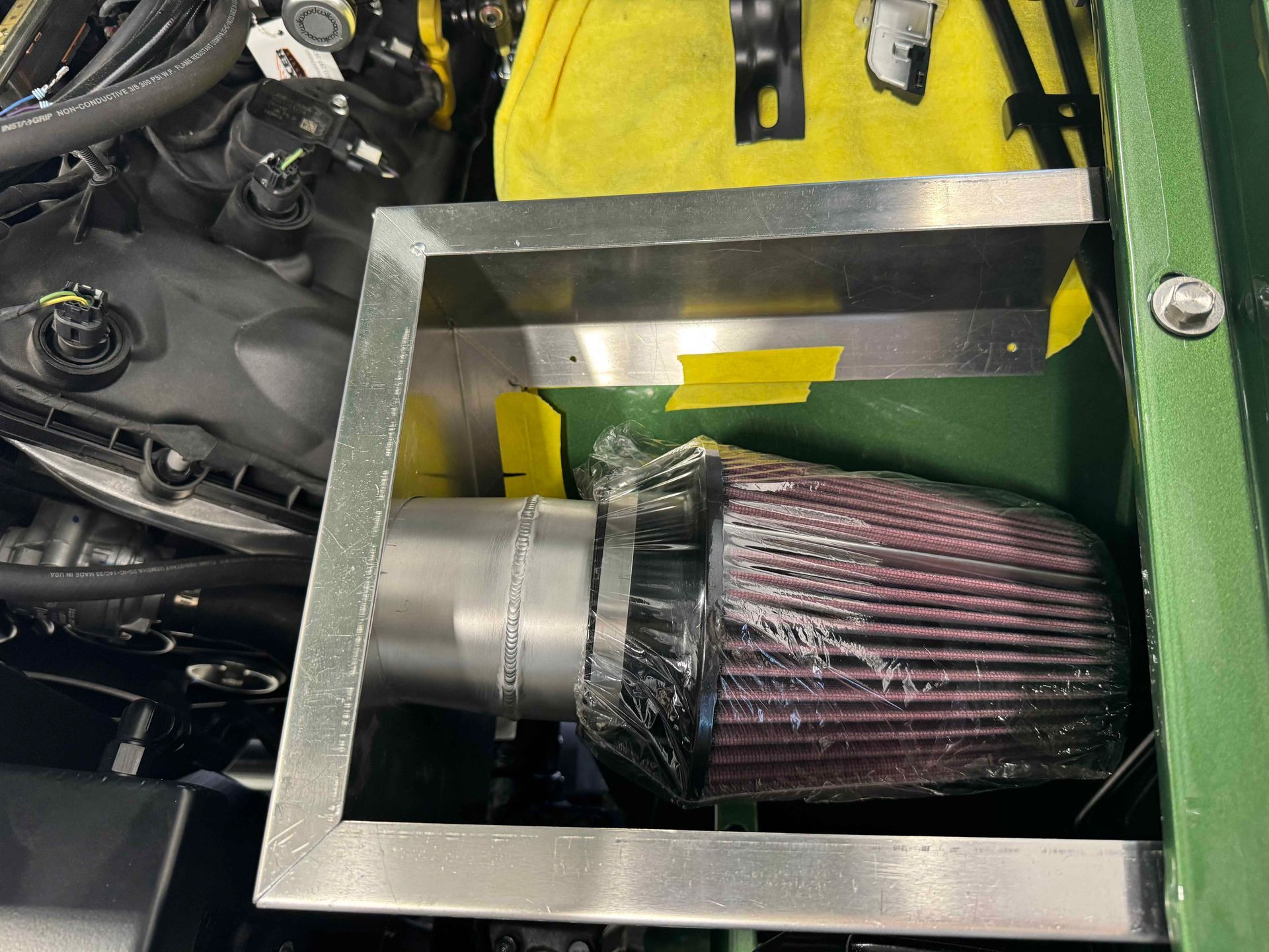 A close up of a air filter in a car engine.