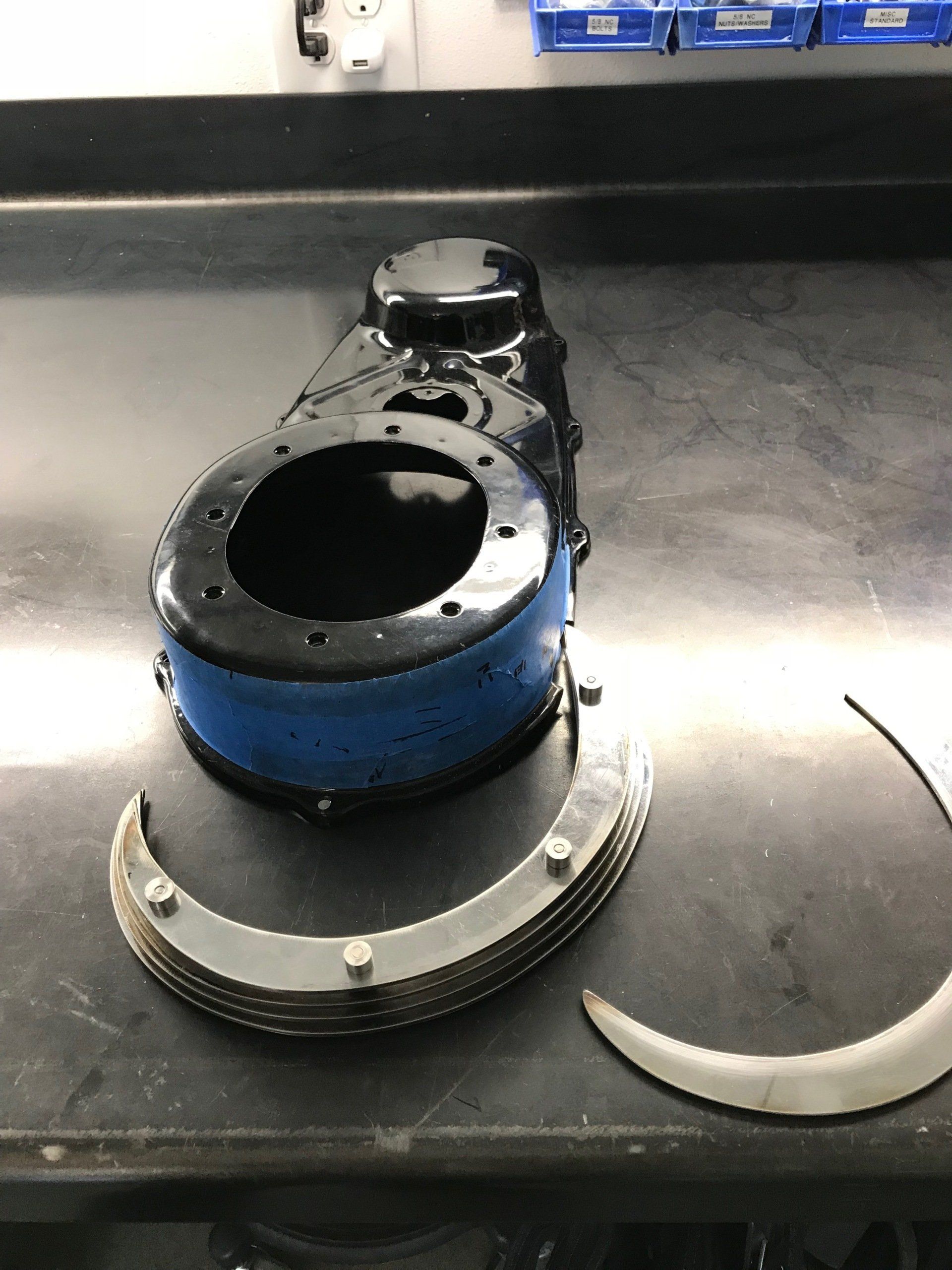 A broken piece of metal is sitting on a table.