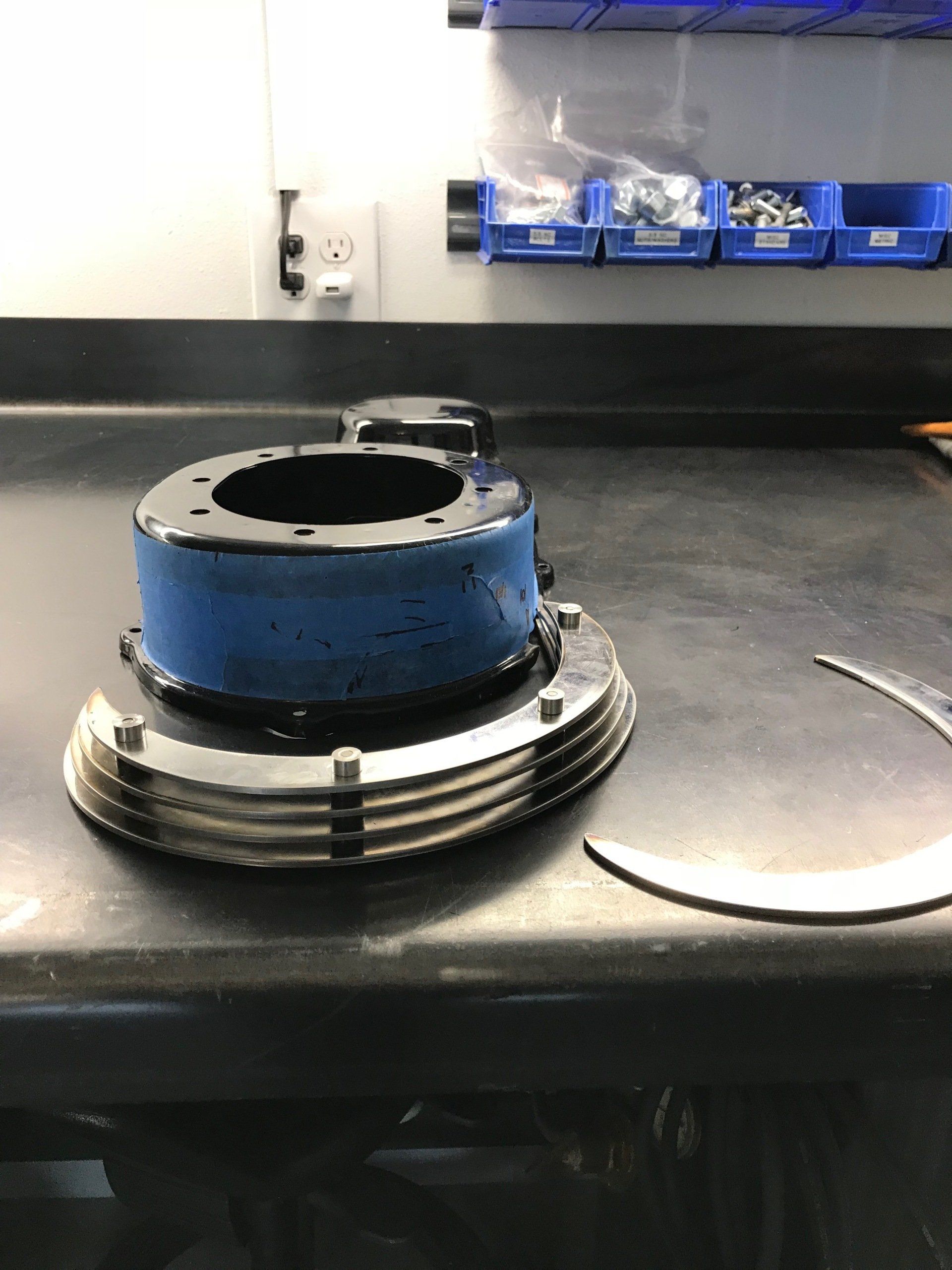 A piece of metal is sitting on top of a black table.