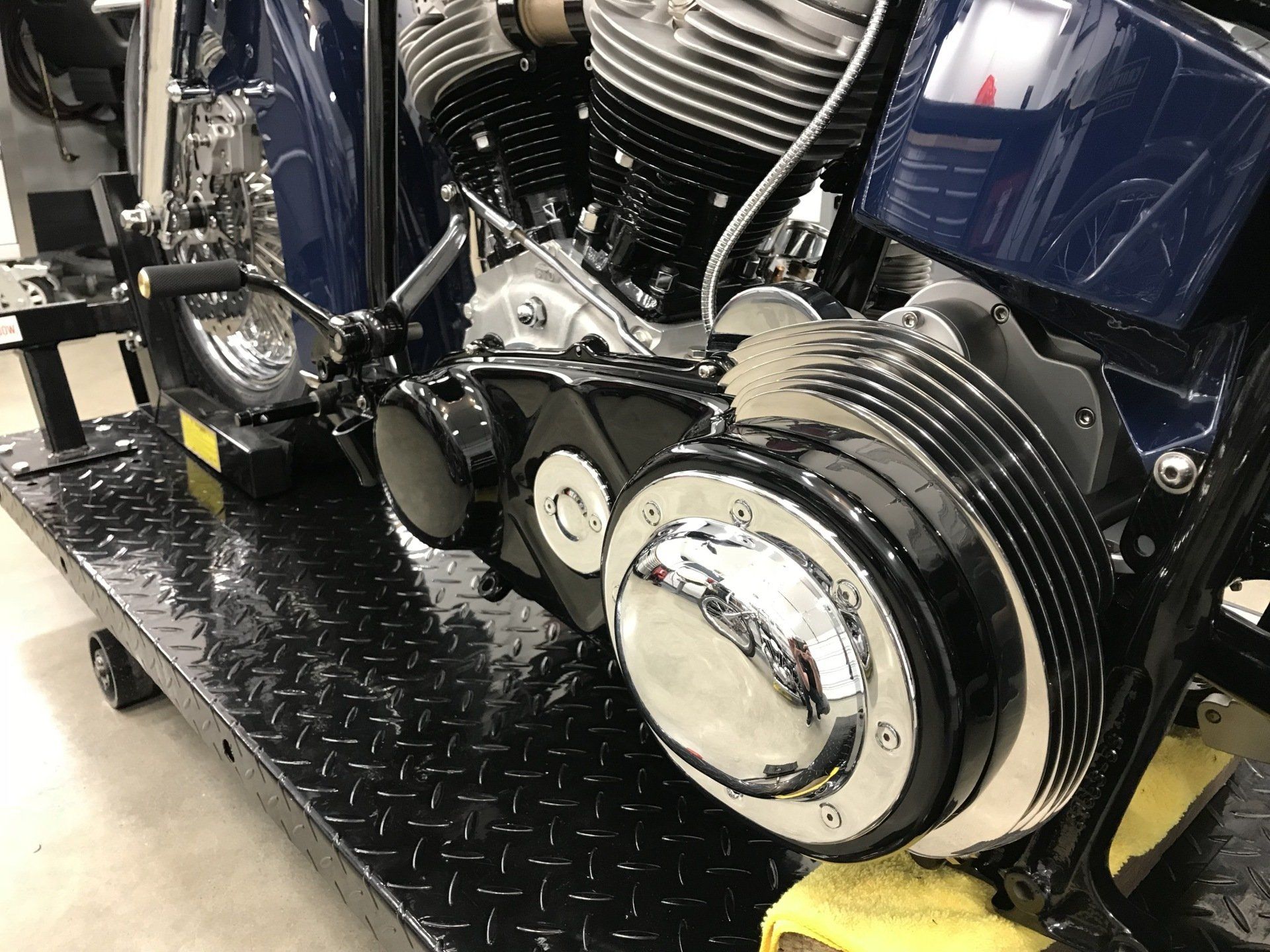 A close up of a motorcycle engine on a ramp.