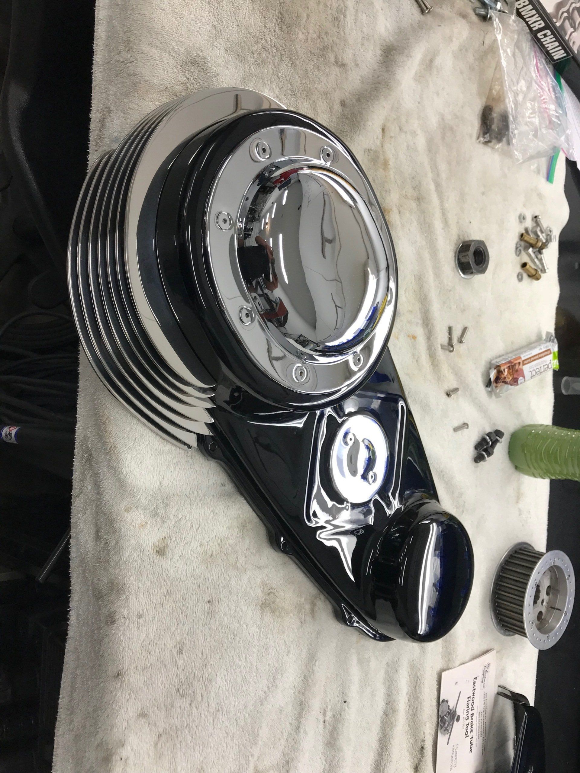 A clock is sitting on top of a white towel on a table.