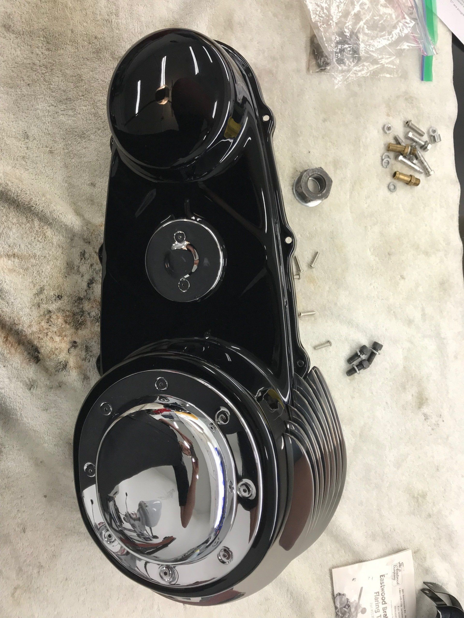 A black and chrome object is sitting on a white cloth