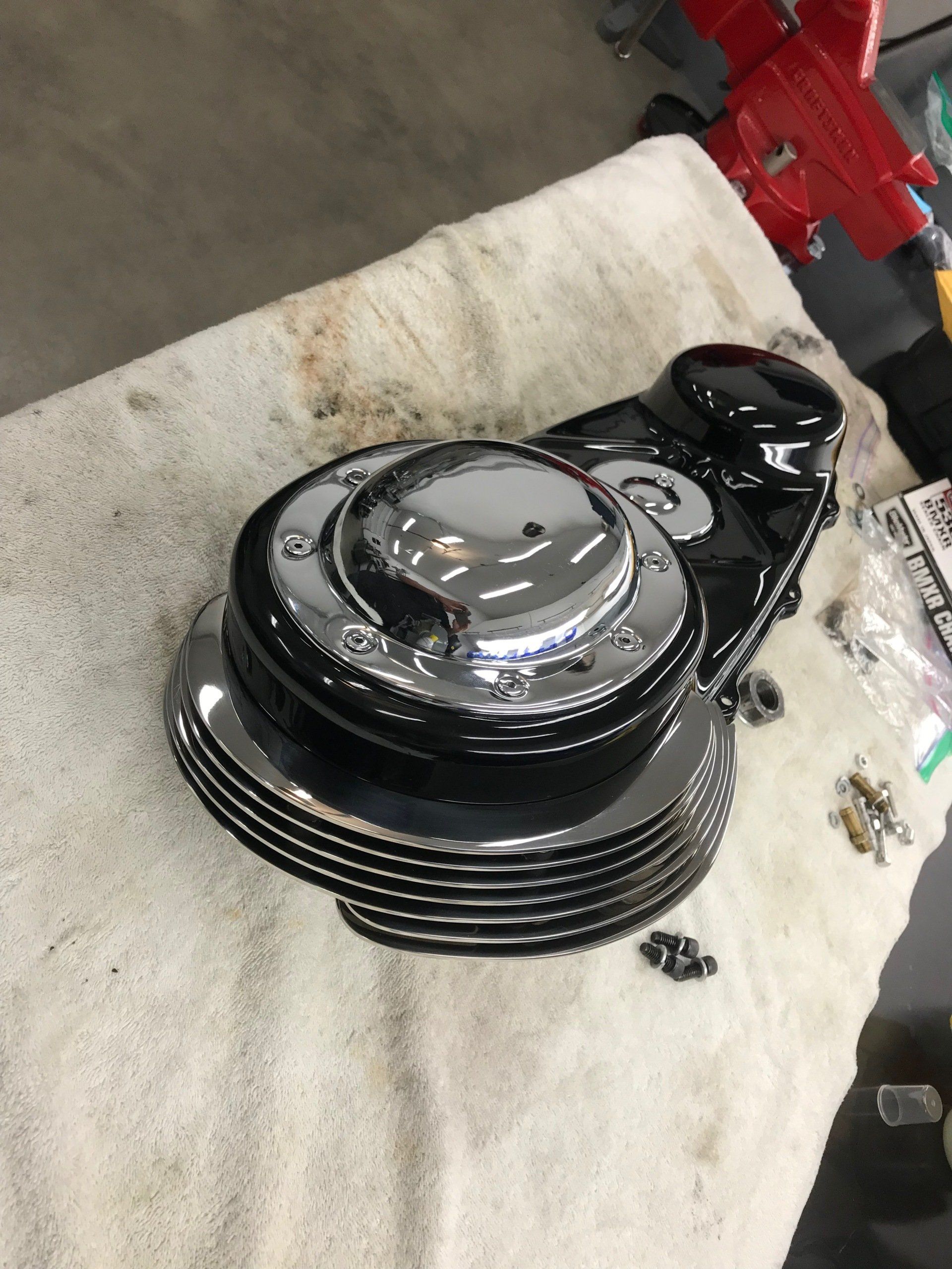 A black object is sitting on a white towel on a table.