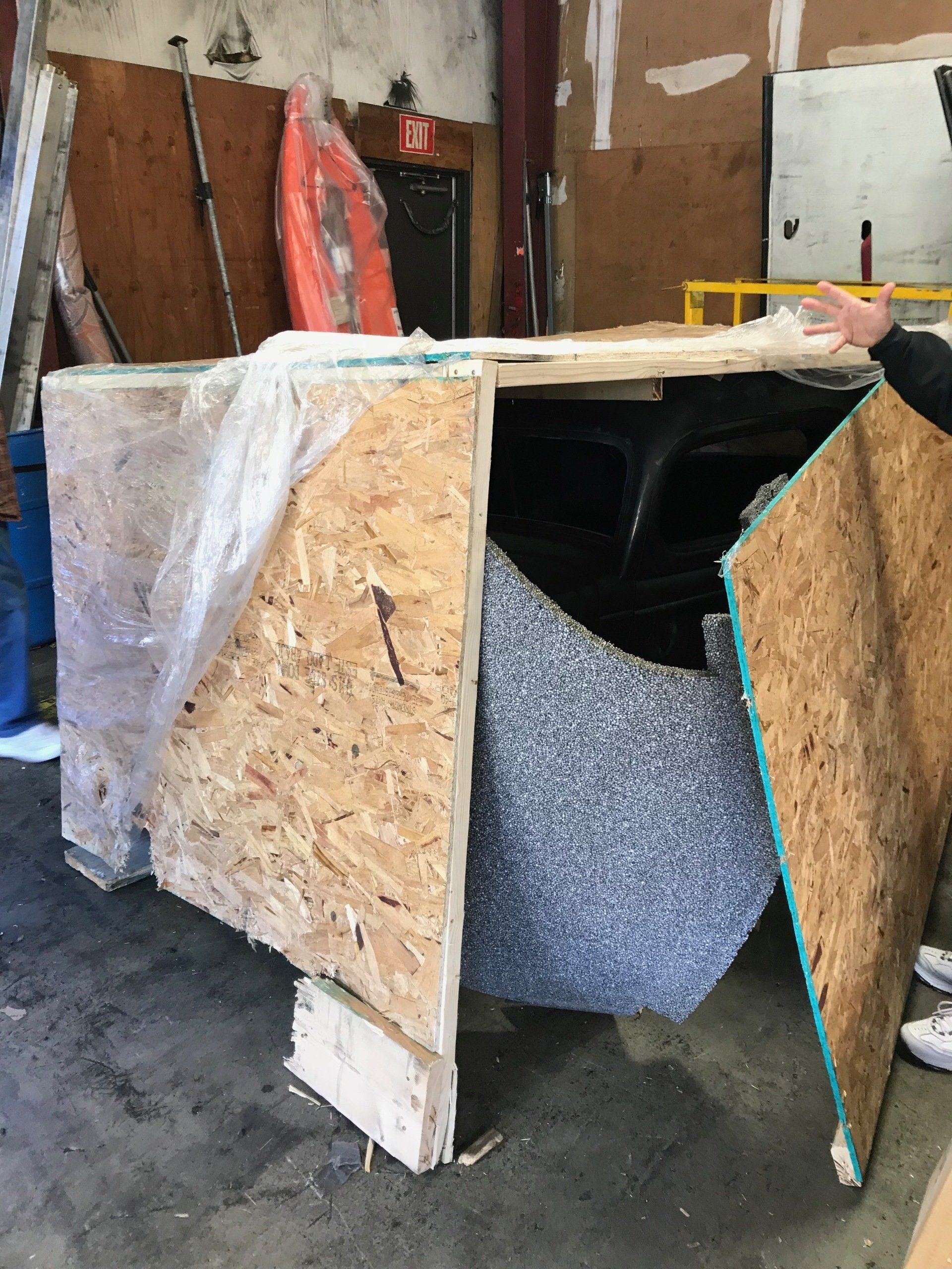 A wooden box with a piece of foam in it