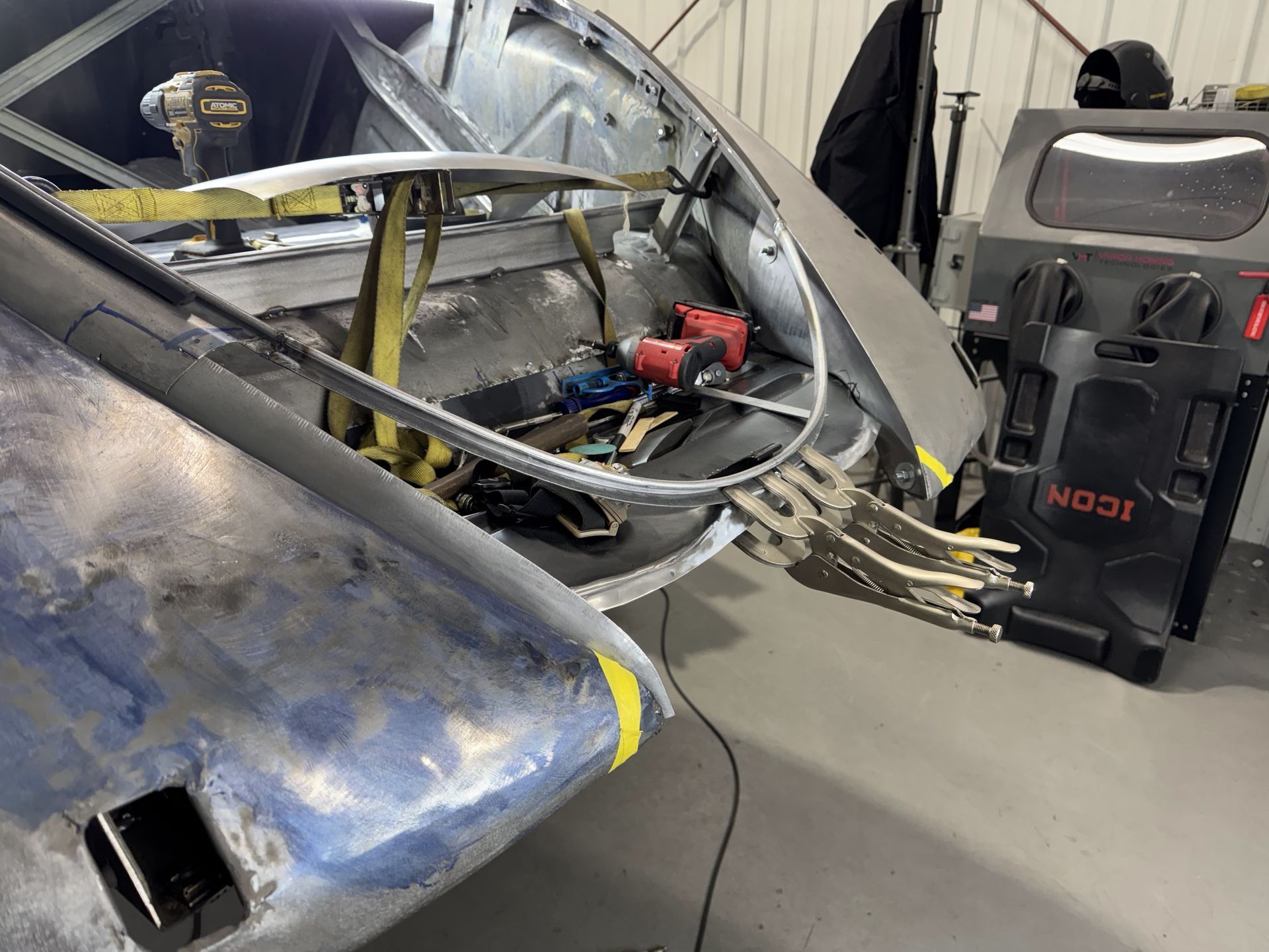 A car is being worked on in a garage.