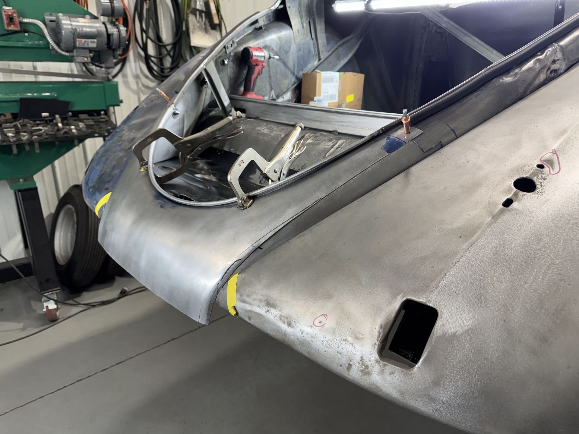 A car is being worked on in a garage.