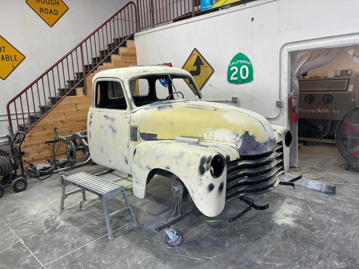 A truck is sitting in a garage with a sign that says 20 on it