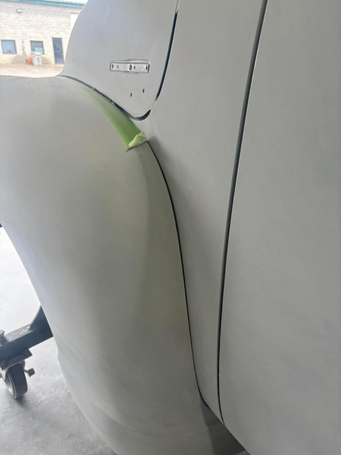 A large white object is sitting on a concrete floor.