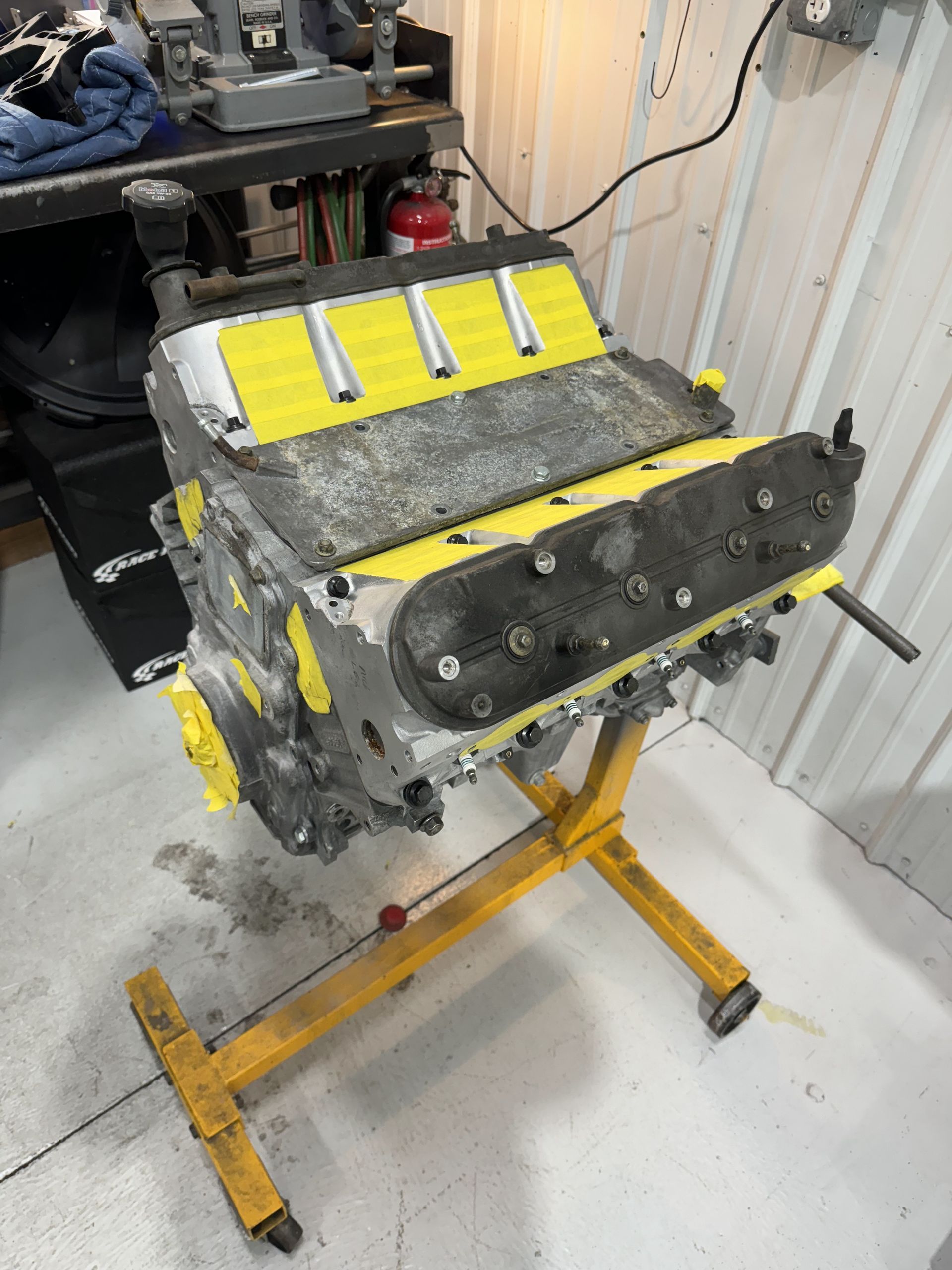 A gray and yellow engine sits on a yellow stand