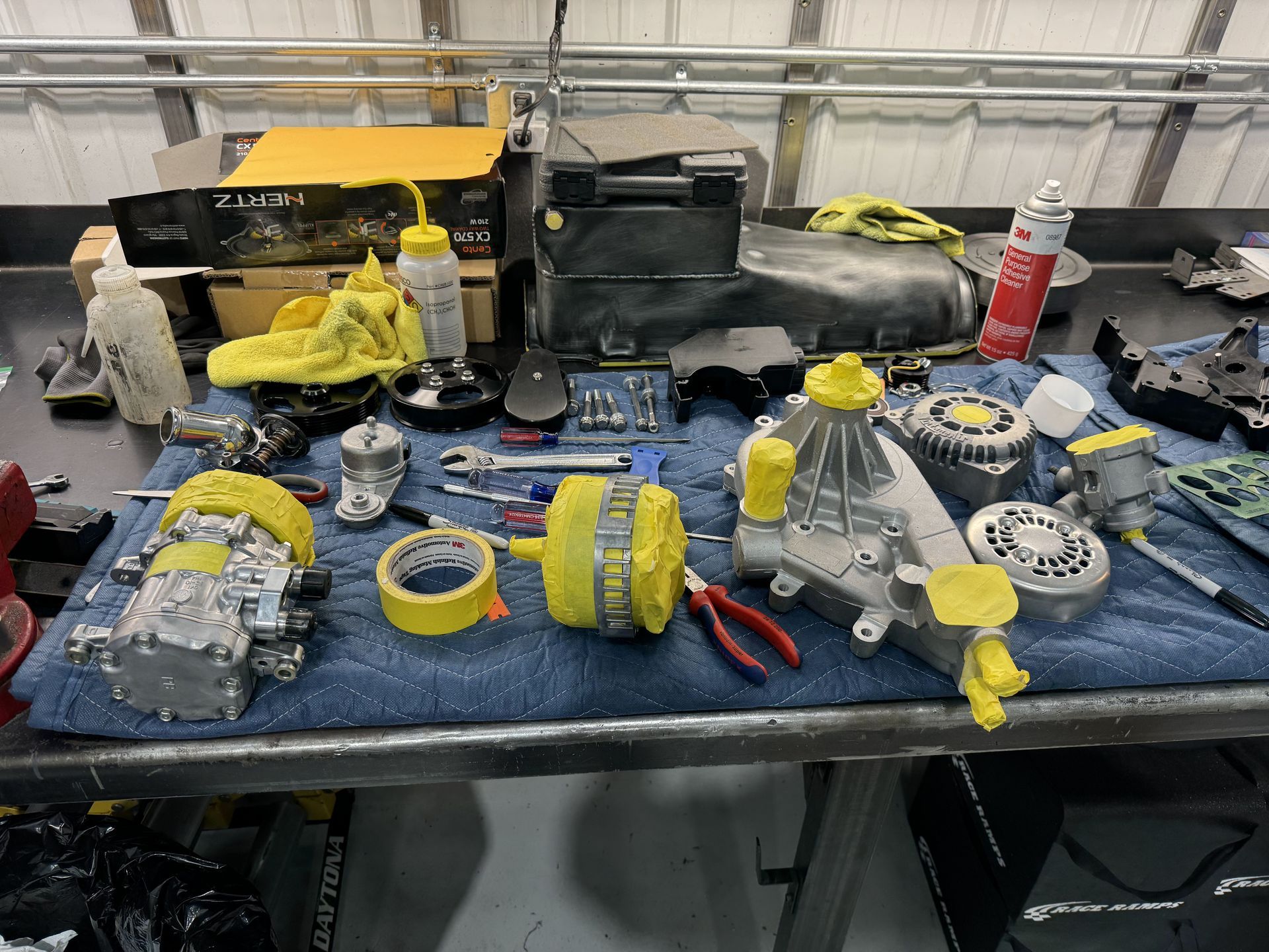 A table with a bunch of tools and parts on it